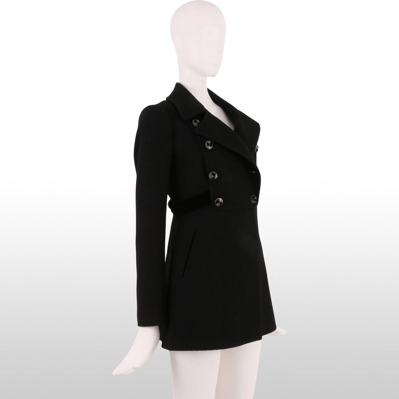 Designed by New Zealand born designer Rebecca Taylor, this classic black wool coat is a great winter staple.  The buttons down each side are covered in a grey wool fabric with jet black and clear beading in a fetching leaf motif. A black velvet belt