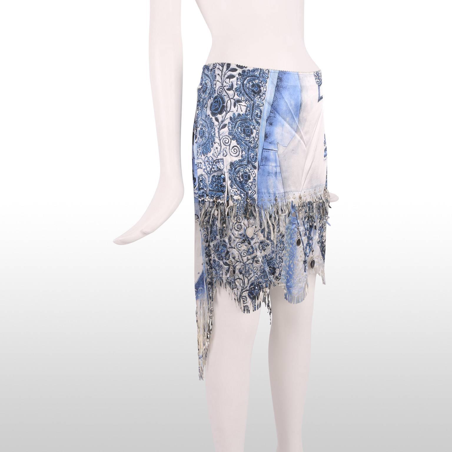 Ethereal light weight skirt from Jean Paul Gaultier. The skirt features a beautiful multi toned blue china pattern with gypsy style shredded hem. Small metallic charms also feature around the hem of the skirt giving it a real beachy and boho feel.