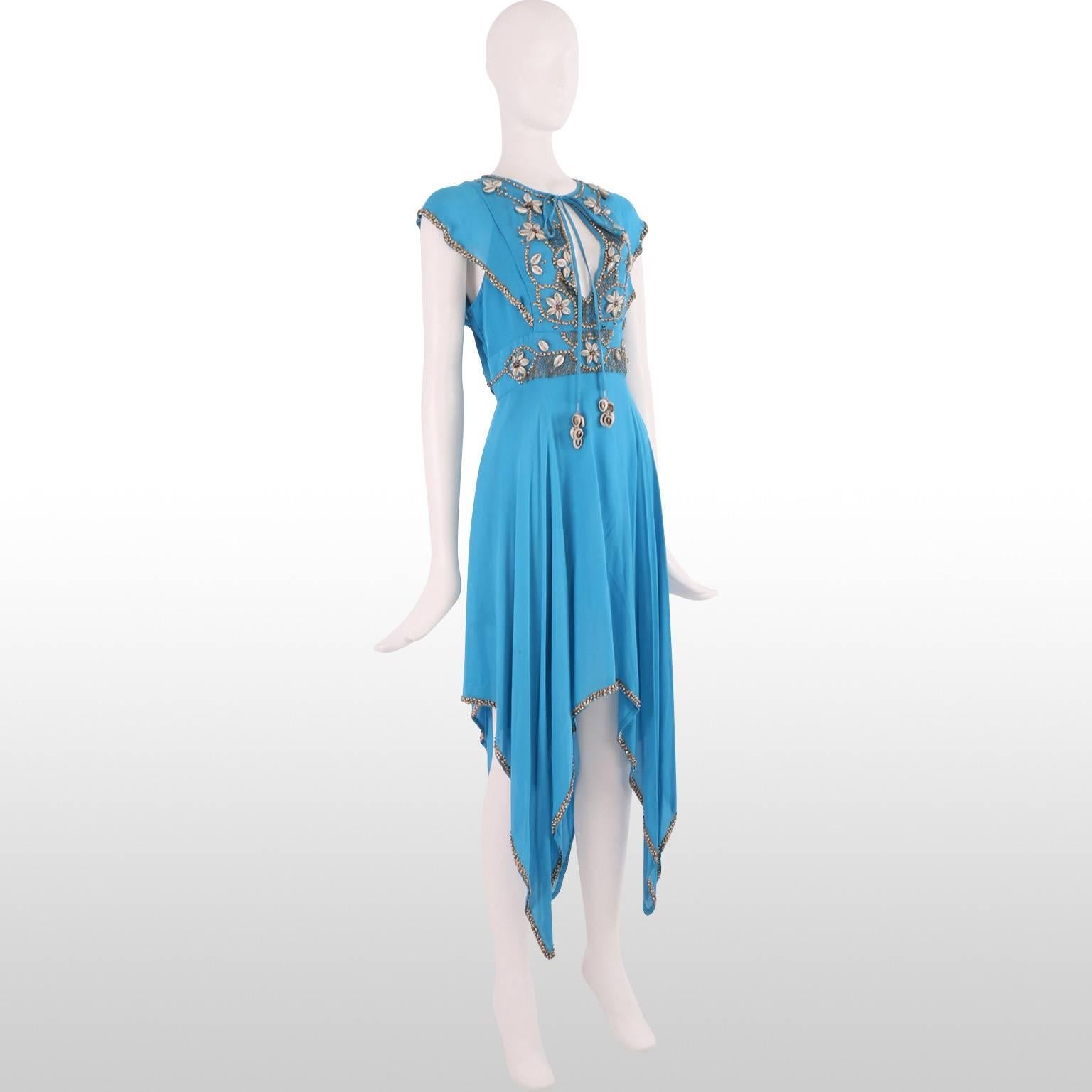 Boho style amazing blue dress designed by Matthew Williamson as part of his Spring 2005 Ready-To-Wear Collection. The dress features intricate shell beaded embroidery around the neck, décolletage and hem giving the piece a summery beachy feel. The