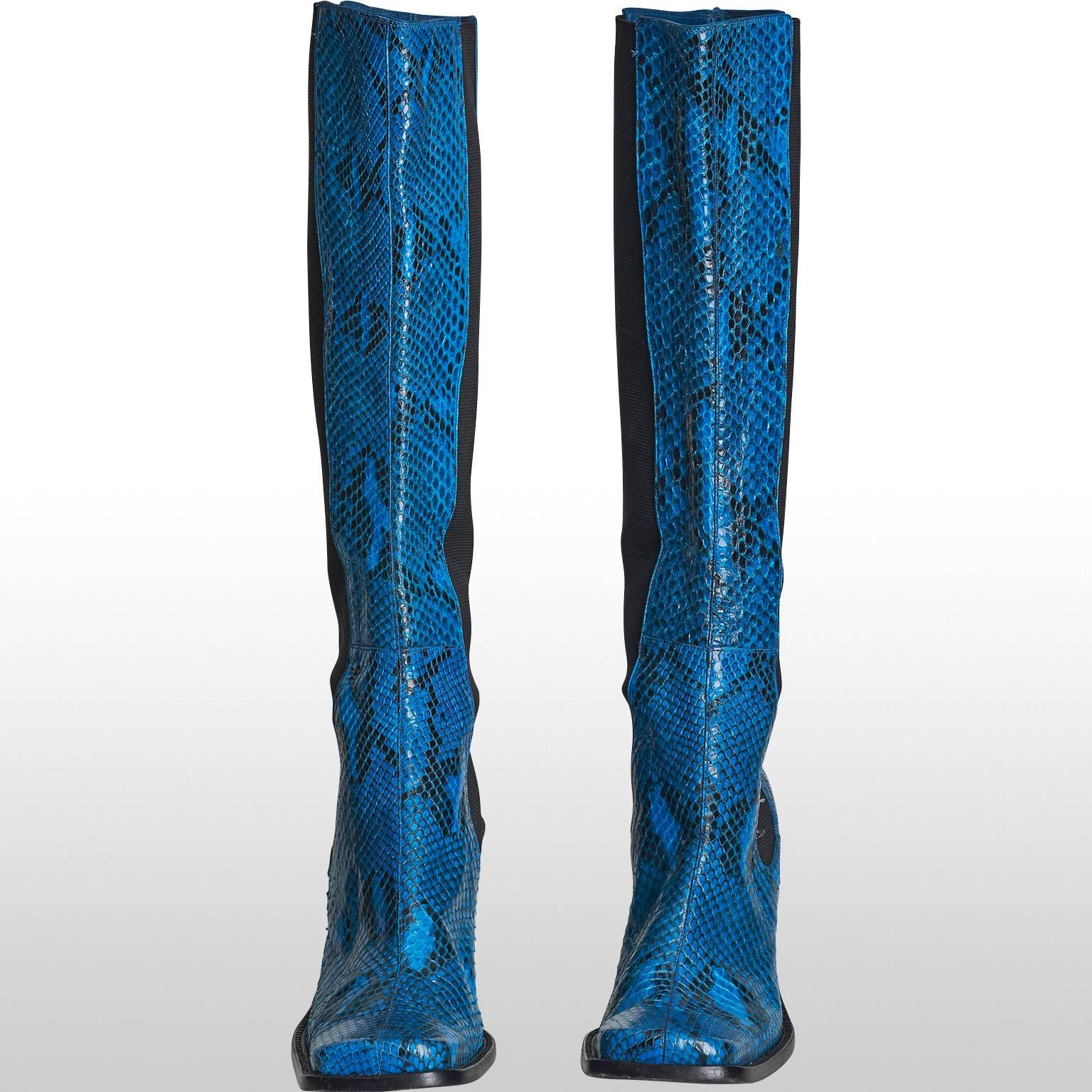 These showstopper boots by the design house Dolce and Gabbana features a vibrant blue and black 100% snakeskin print with squared toes and stiletto style heel. Stylish and sexy, these boots are perfect for those fashionistas who really want to stand
