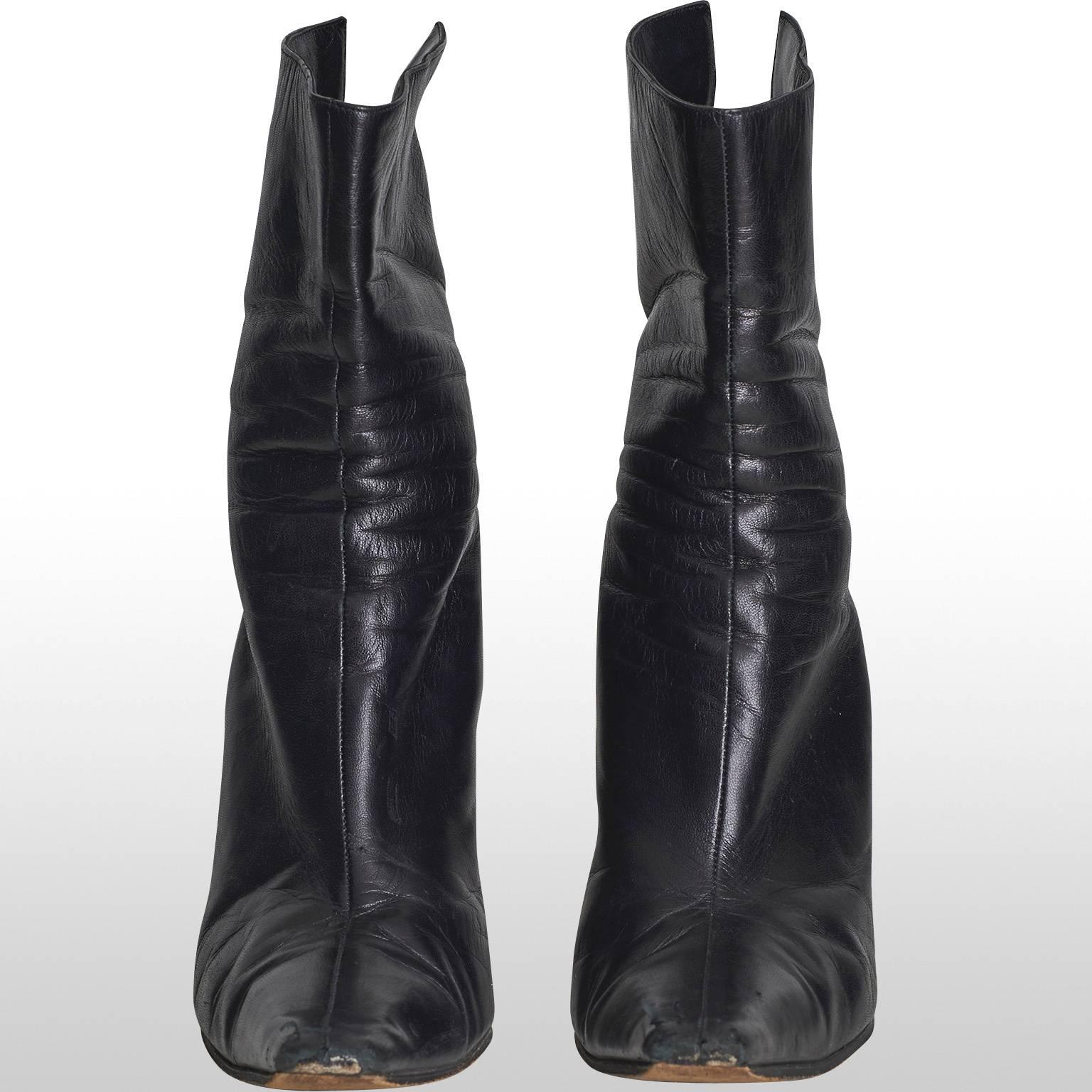 Chic black leather Jimmy Choo boots with small, thin heel. These boots sit comfortably just above the ankle, featuring a pointed toe and zip fastening at the back. Classic and smart, these boots can be pared with almost any outfit from jeans to