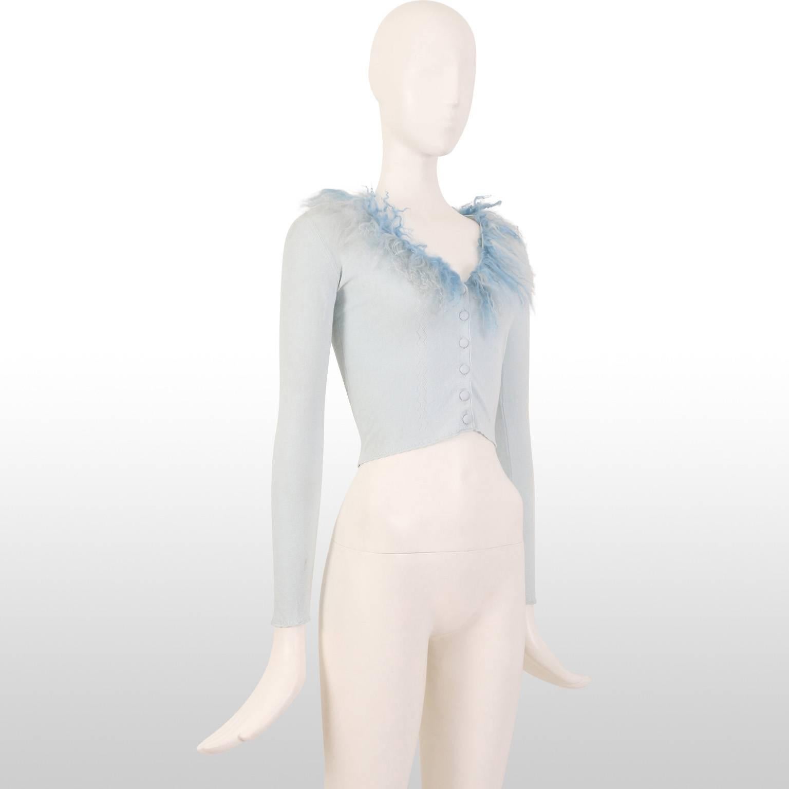 The Italian brand Blumarine excels in truly feminine fashion as is evident by this delicate cropped sky blue knit cardigan. The collar is trimmed in a two tone curly wool and has zigzag detailing down the front. 
Measurements:
Length 15