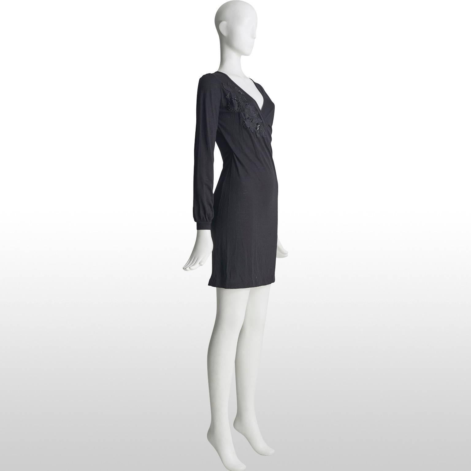 Vanessa Bruno black v neck wrap over style dress featuring an applique floral detailing down the right side of the dress. Simple, yet striking, this piece is perfect for day way and can easily be transitioned from the office to the cocktail bar.