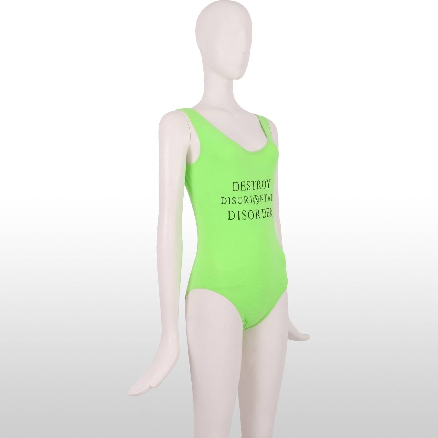 This vintage 1980's John Richmond acid green 'Destroy Disorientate Disorder' Body combines the atmosphere of the Club Era with sportswear chic. Ideal to wear to a Summer festival, or simply paired with jeans and a casual jacket. This piece is in