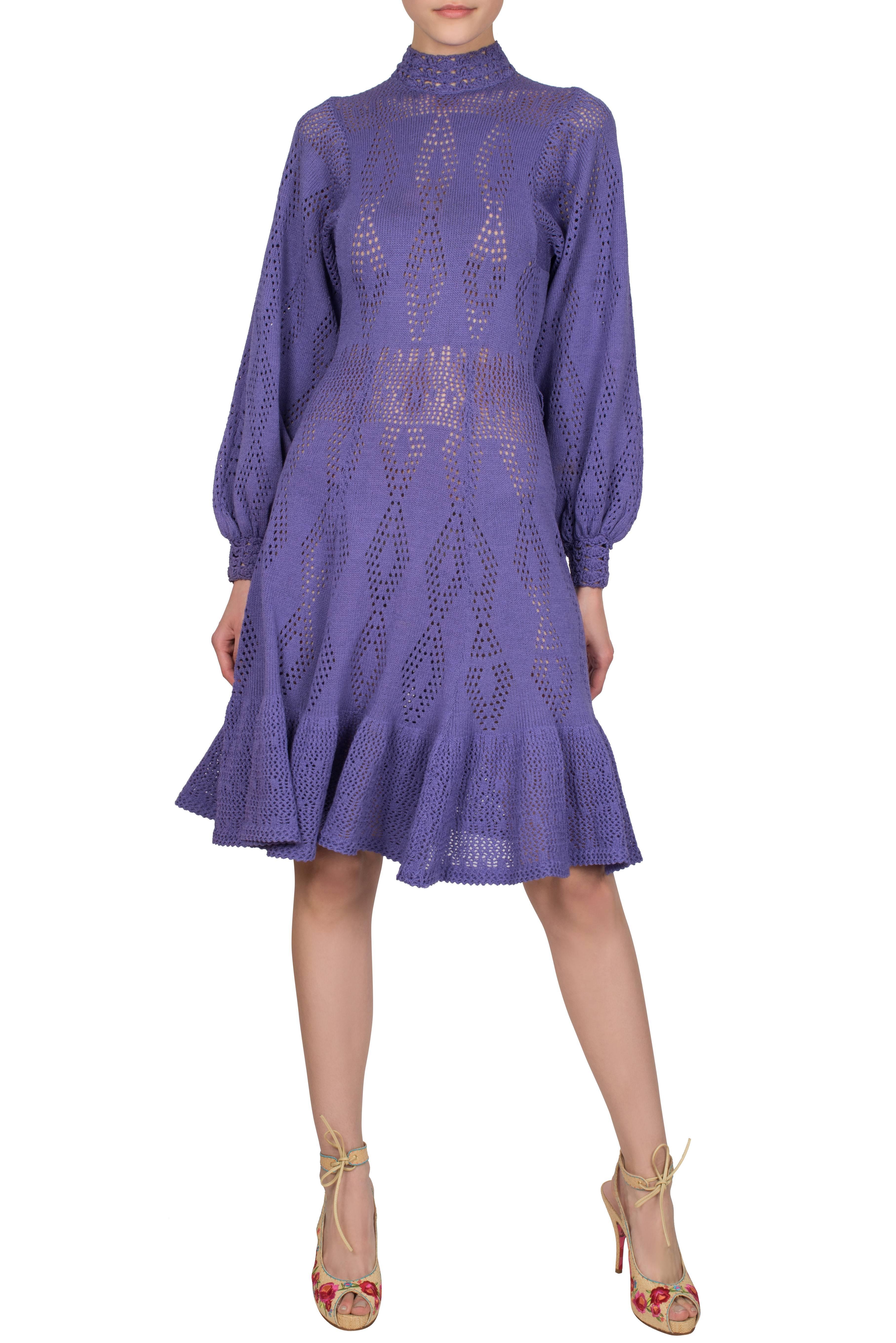 An incredibly feminine 1970's dress from St John. Made from a soft lilac crochet knit, the dress features bishop sleeves and a godet skirt. There are no seams attaching the sleeves to the bodice, with the cuffs and high collar being made from
