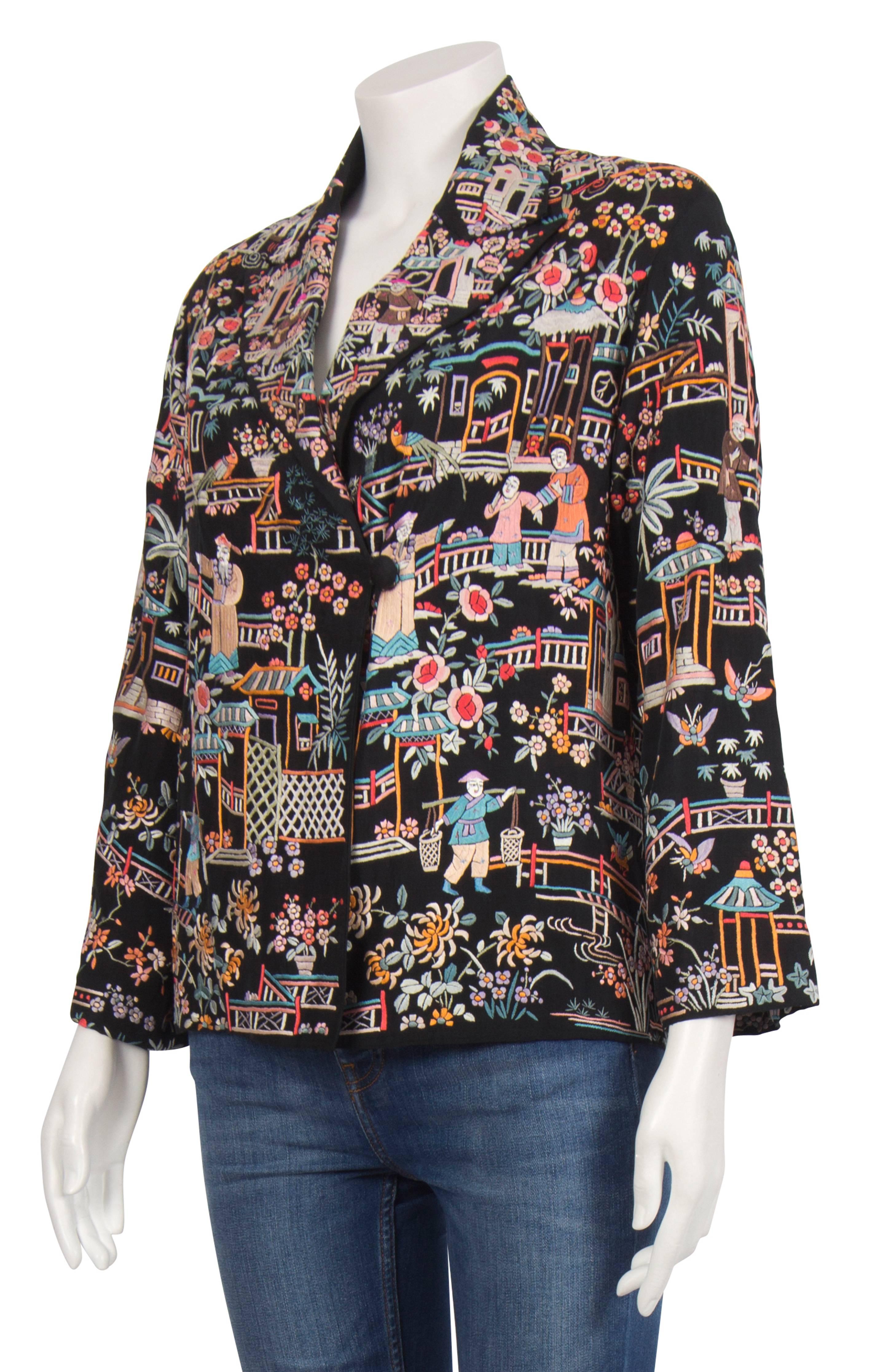 A 1940's black jacket with colourful Chinese garden scene embroidery in pastel colour silk thread. The jacket has a boxy fit and it's made from and lined with pure silk, making it extremely soft and lightweight. It has a double breasted fastening