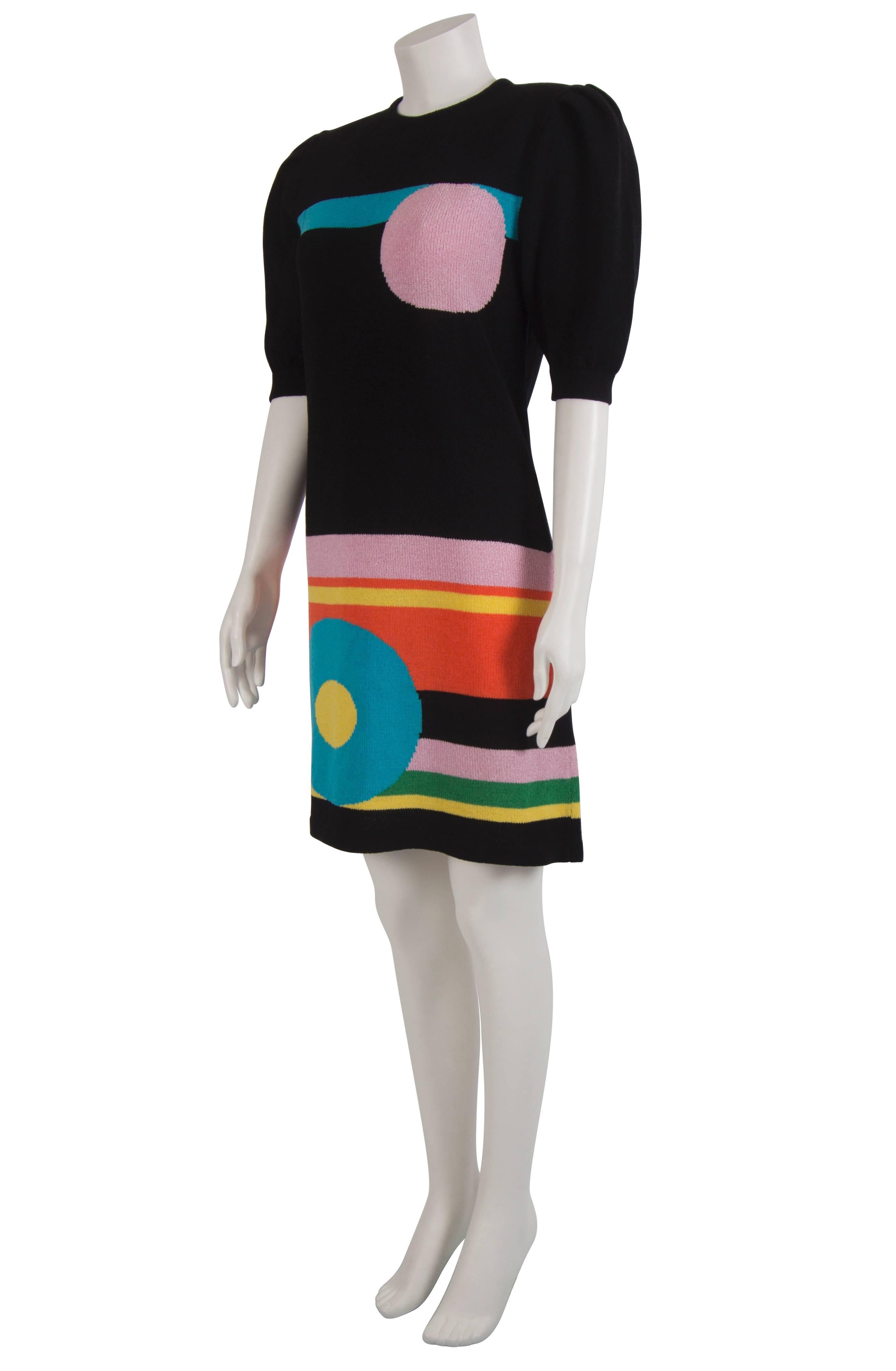 Bold and bright 1980's geometric print wool knitted knee length dress with puffed sleeves. The dress is unlined and fastens with a zip at the centre back. Although it has no labels present, the pattern is from a 1966 Pierre Cardin dress