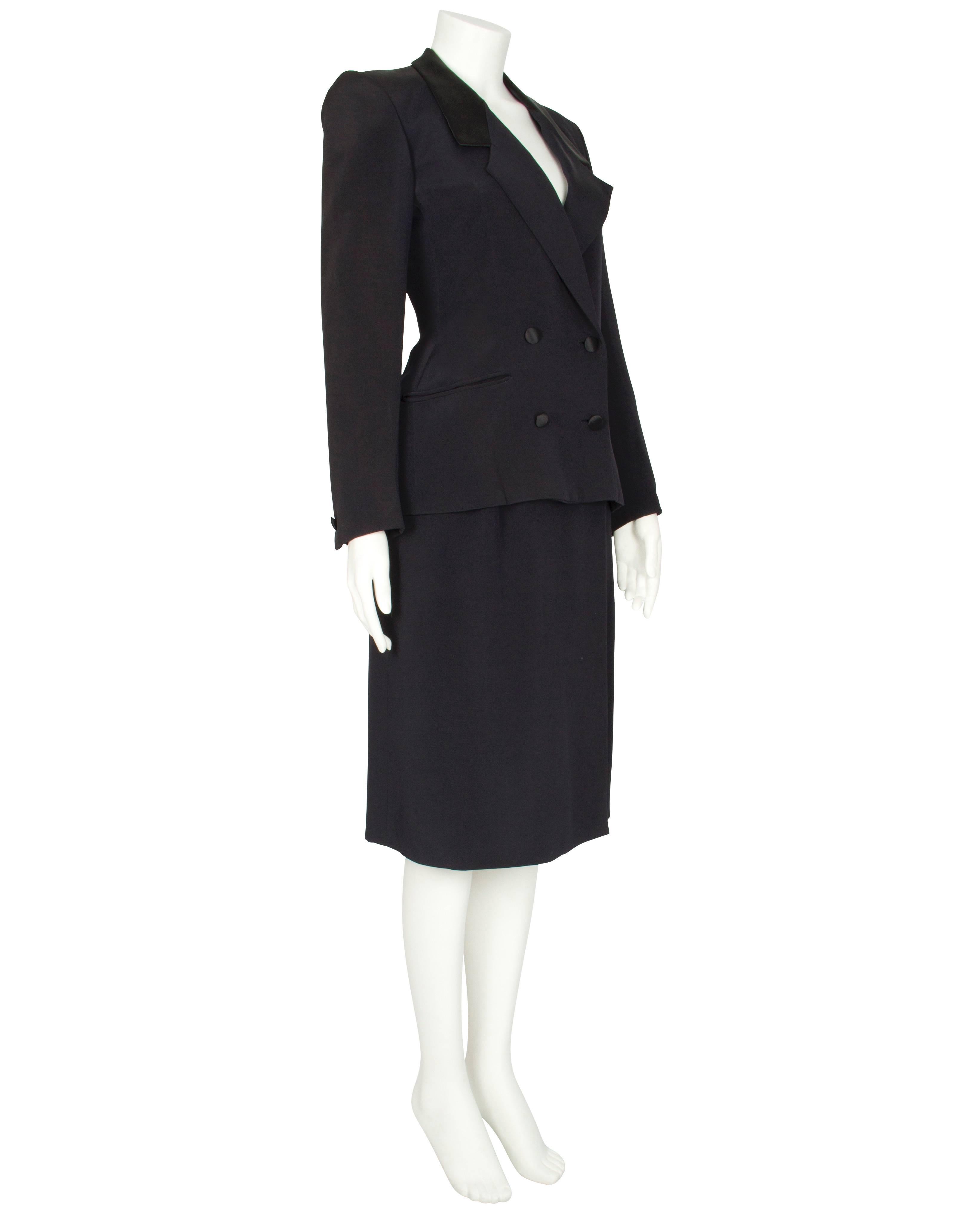 A classic 1980s Dior Couture navy silk satin double-breasted jacket and wrap skirt suit. The tuxedo-style jacket is fitted at the waist and features long sleeves, slightly padded shoulders, a notched collar with wide lapels and two hip welt pockets.