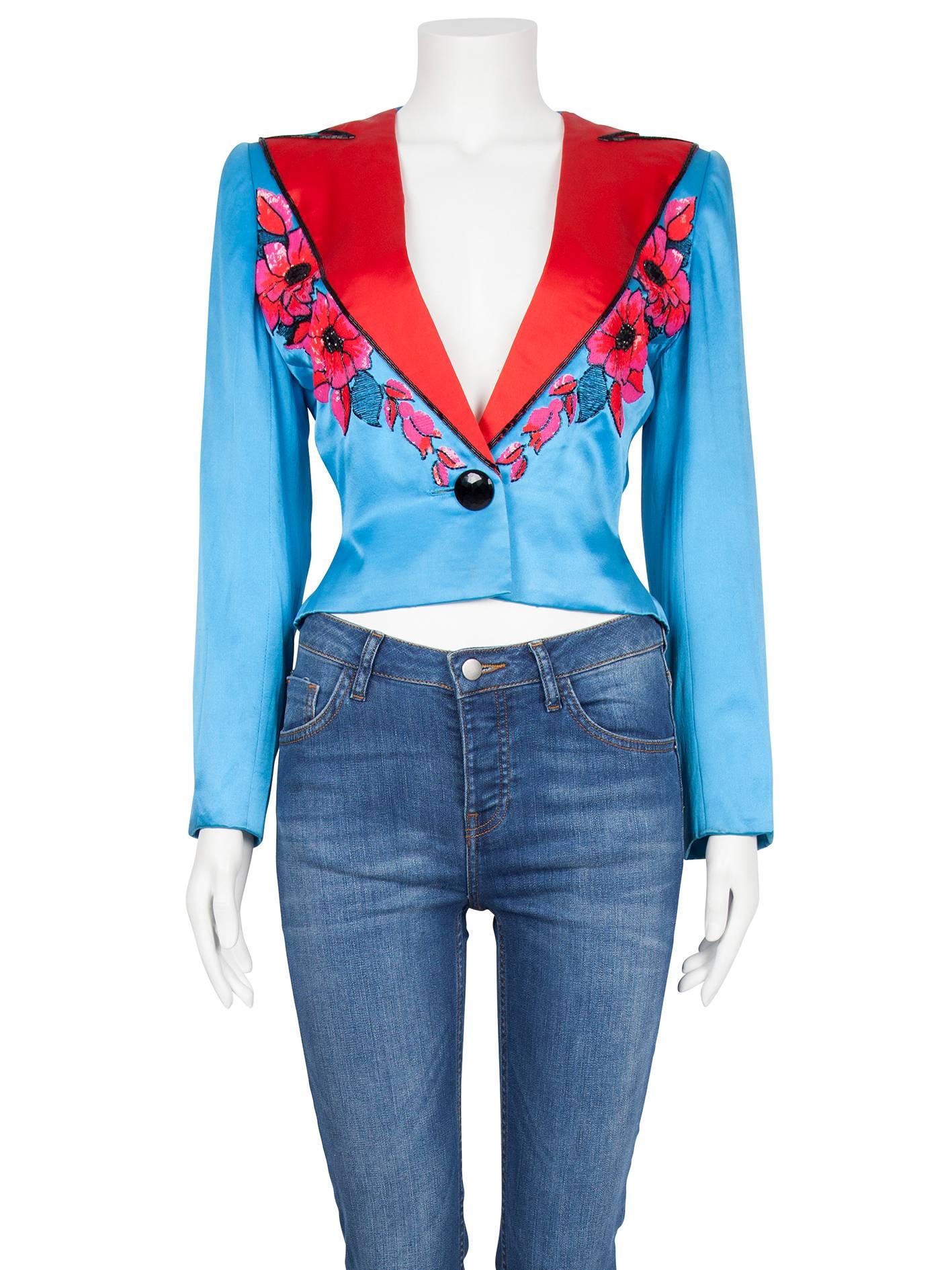A rare Christian Dior couture bright blue silk boxy jacket from the Spring/Summer 1983 collection. The soft-shaped fitted jacket is constructed from bright blue silk with red silk lapels trimmed in black beading and features striking pink and red