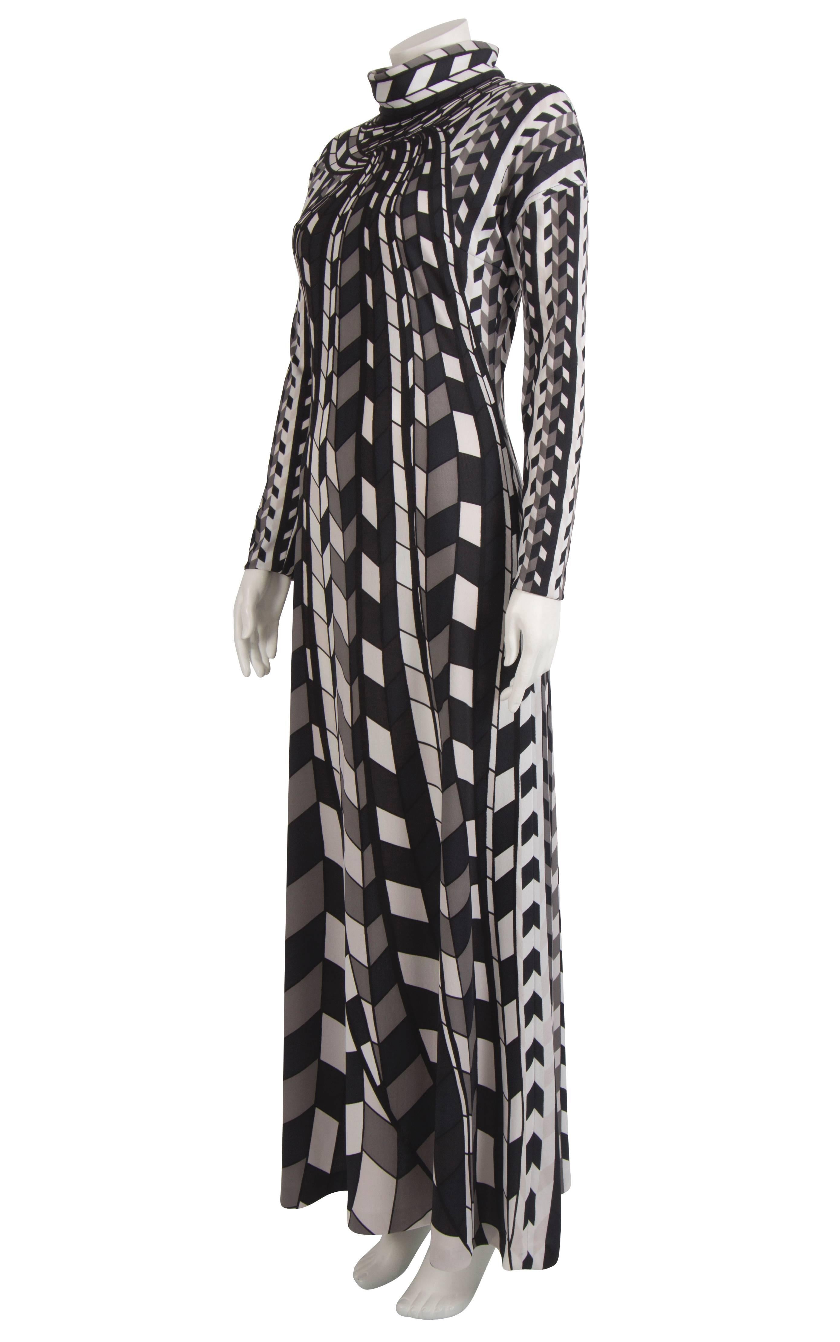 A 1970's Roberta di Camerino trompe l'oeil cubist monochrome column dress. Made from a soft polyester knit, the dress features long sleeves and a polo neck. The pattern on this dress features cubes in different dimensions which seem to move upwards