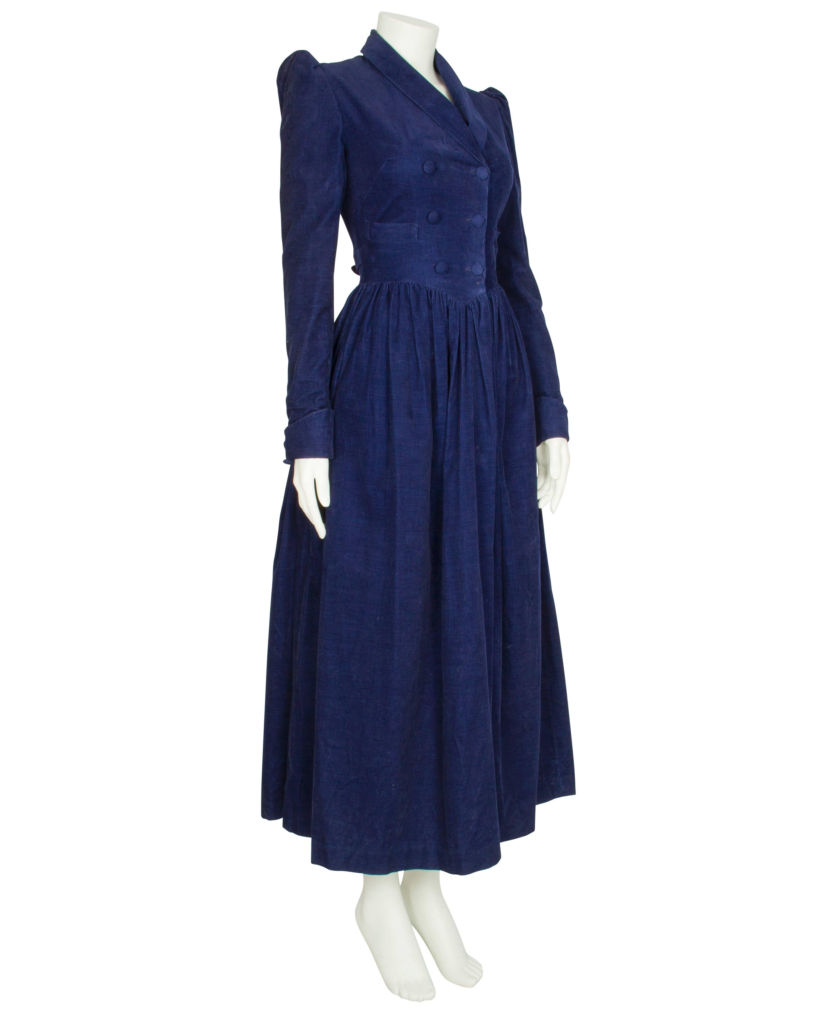An incredibly feminine 1970s cotton corduroy dress by label Pollen London. The dress features a double breasted bodice with puffed sleeves and a mock-French cuff, which rolls up with two decorative buttons. The skirt gathers from the pointed waist,
