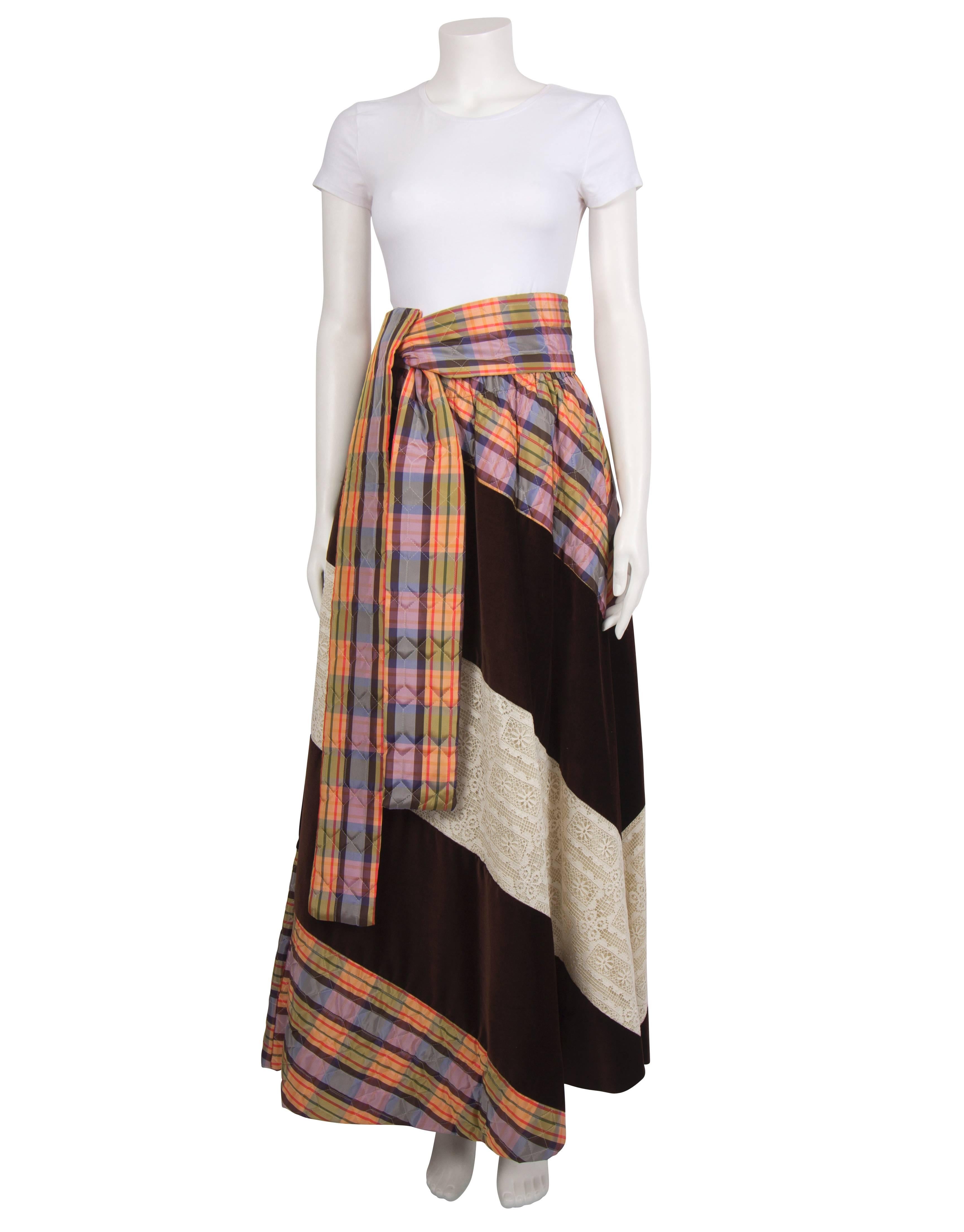 A beautiful example of Chessa Davis' signature patchwork designs, this skirt is made from diagonal panels of brown velvet, cotton lace and a quilted plaid in lilac and orange. The skirt is lined in soft cotton and has an elasticated waist. A wide