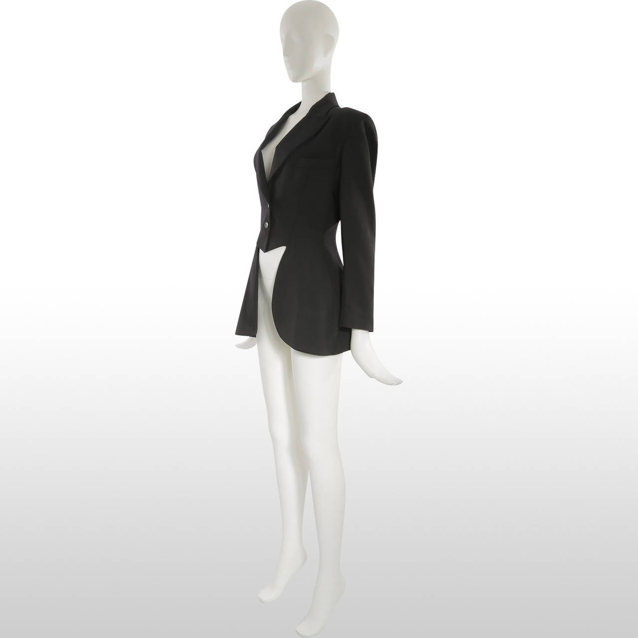 This incredibly cool jacket by Alaia is made in the style of a circus ringmaster for the female form. Its peaked lapels and tails are beautifully tailored with a button to secure the vent at the back. There is a small amount of padding in the