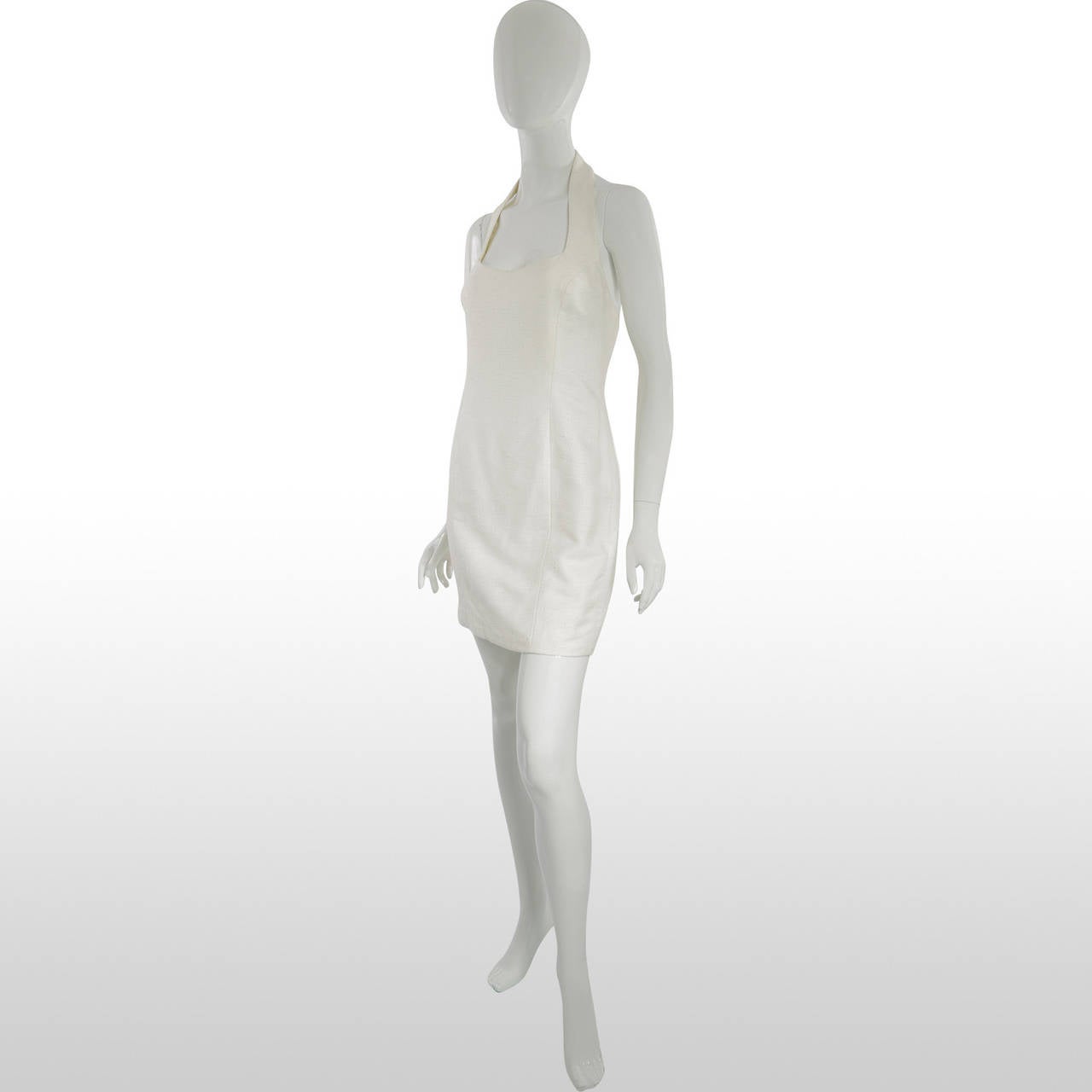 This 1990’s little white dress is custom made by British Designer Bruce Oldfield and is made from a woven textured linen. It has a fitted bodice which is structured with boning and the skirt fits to the hips in a straight fashion. The neckline is