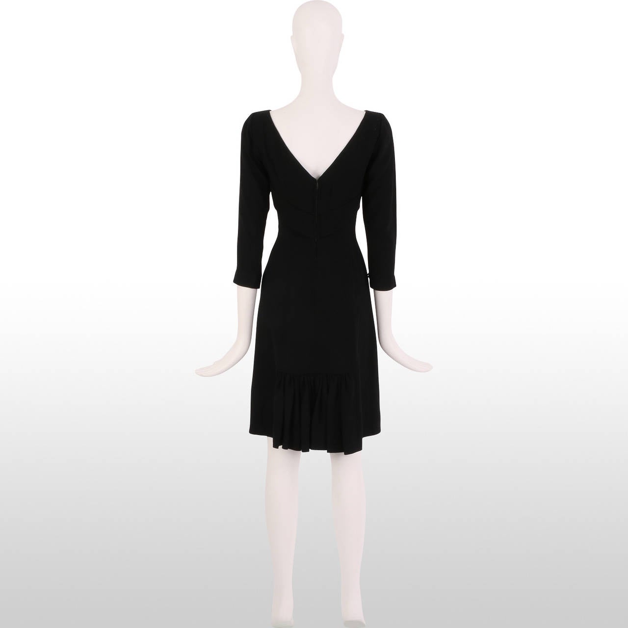 We are in love with this beautifully classic late 1940's early 1950's little black cocktail dress by Eisenberg Originals. It is made from black crepe fabric and is simplistically elegant in its shape and structure with 3/4 length sleeves, nipped