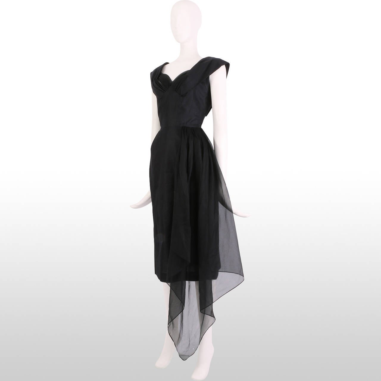 This unique dress from the 1950's is a great little LBD to wear for this party season. The sweetheart neckline is detailed with pleated chiffon to accentuate the bust and the wide shoulders straps create an elegant capped effect. The reverse lapels