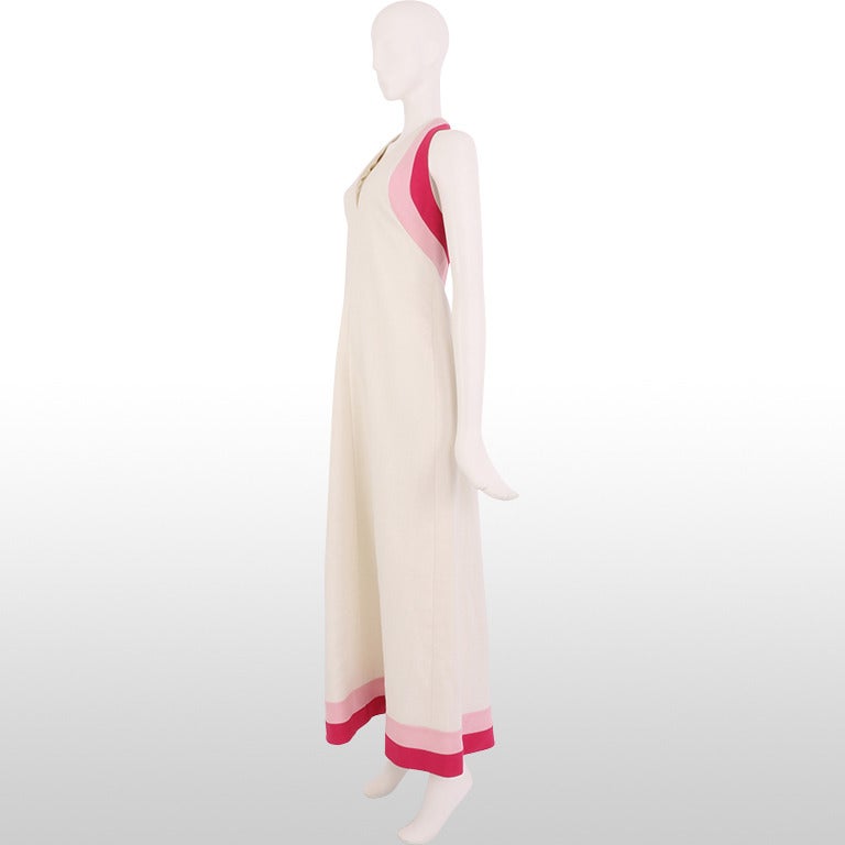 Gorgeous 1970's Lord and Taylor maxi dress features a crisp white linen fabric with a pop of bright fuchsia and dusty pink under the arms and around the hem. The A-line cut allows the body to move comfortably within the dress which is perfect for