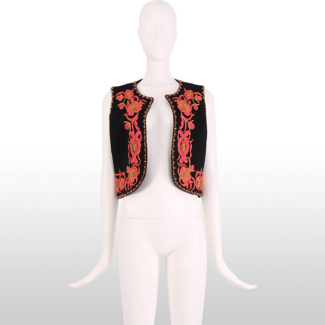 This gorgeous little 1960's folk vest is a great, unique and fresh addition to your summer outfit this year. It is beautifully made and hand embroidered with with hot pink florals with gold metallic detailing. The vest is also immaculately trimmed