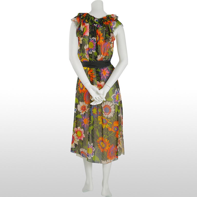 This gorgeous floral Viktor and Rolf dress is a from their 2003 ready-to-wear collection. The beautiful printed silk depicts a brightly coloured large floral pattern on a black background. The silk is light and delicate and has a semi-translucent