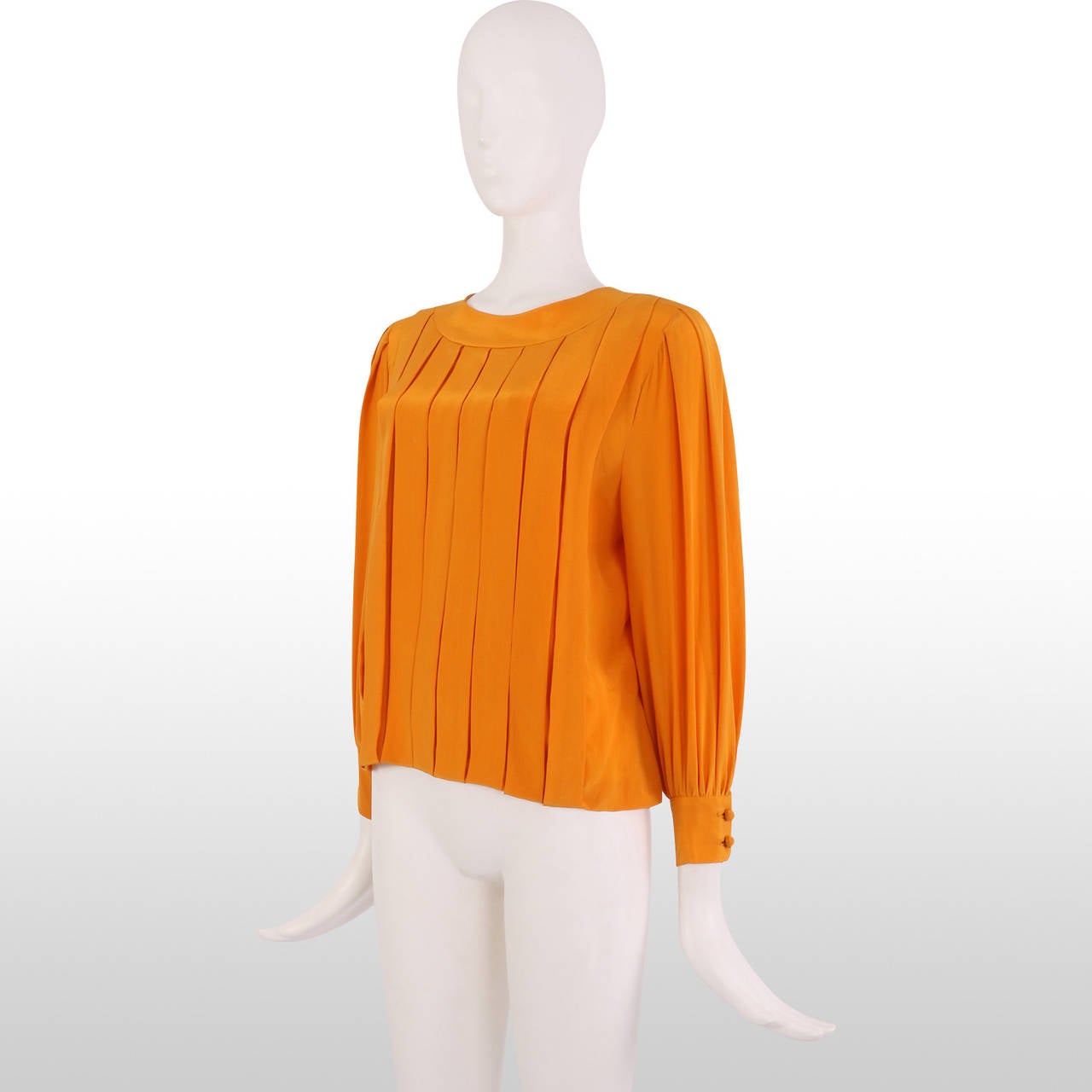 This gorgeous Hardy Amies blouse is the perfect transitional piece in the summer months whilst the sunburst orange colour allows the blouse to inject colour into your wardrobe and the beautiful pleated front adds an extra statement. The blouse