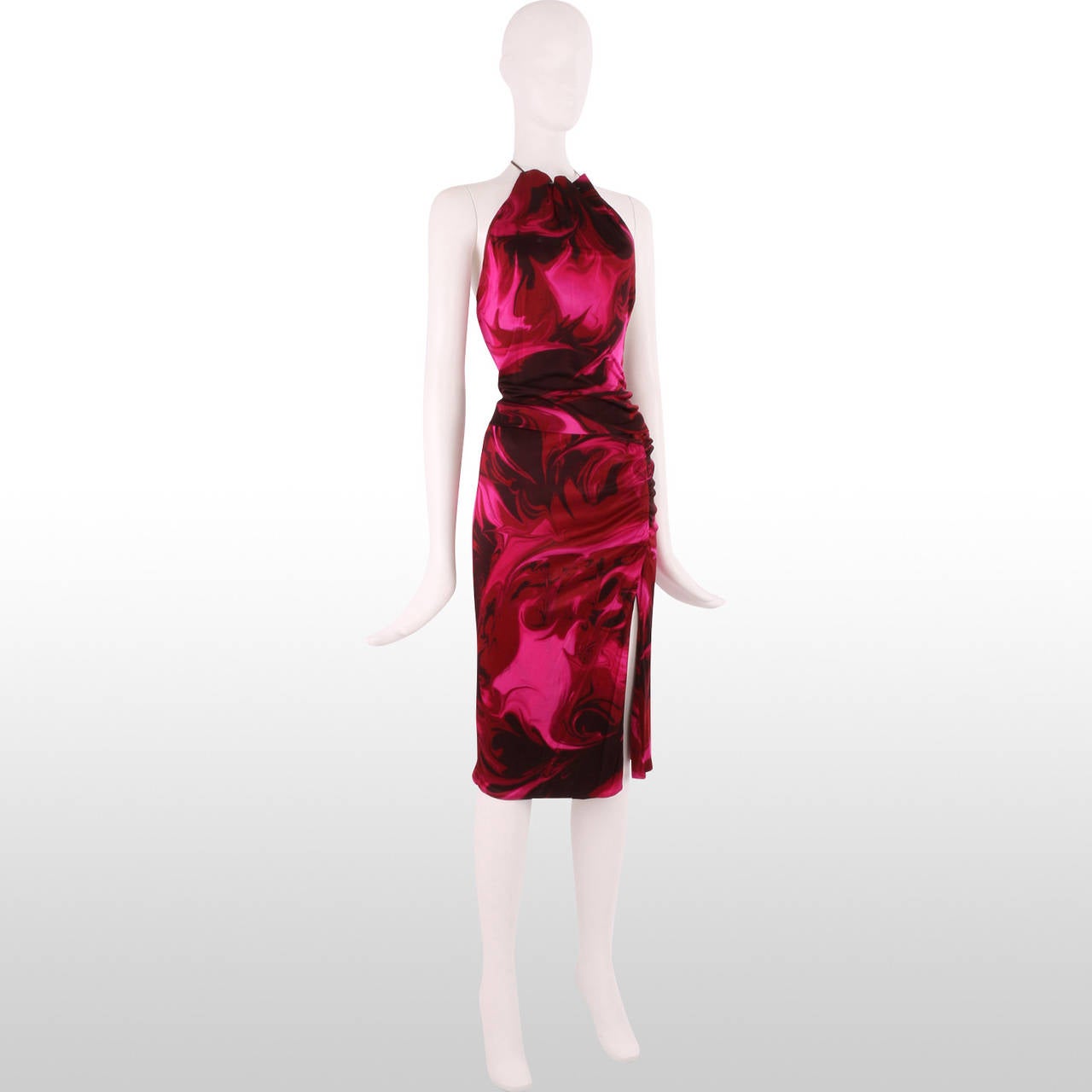 This two-piece by Gucci is composed of a cropped halter neck top and knee length side split skirt. The fabric is really what makes this piece special as the bold marble effect, swirl print in tones of rose pink brings real vibrancy to the outfit.