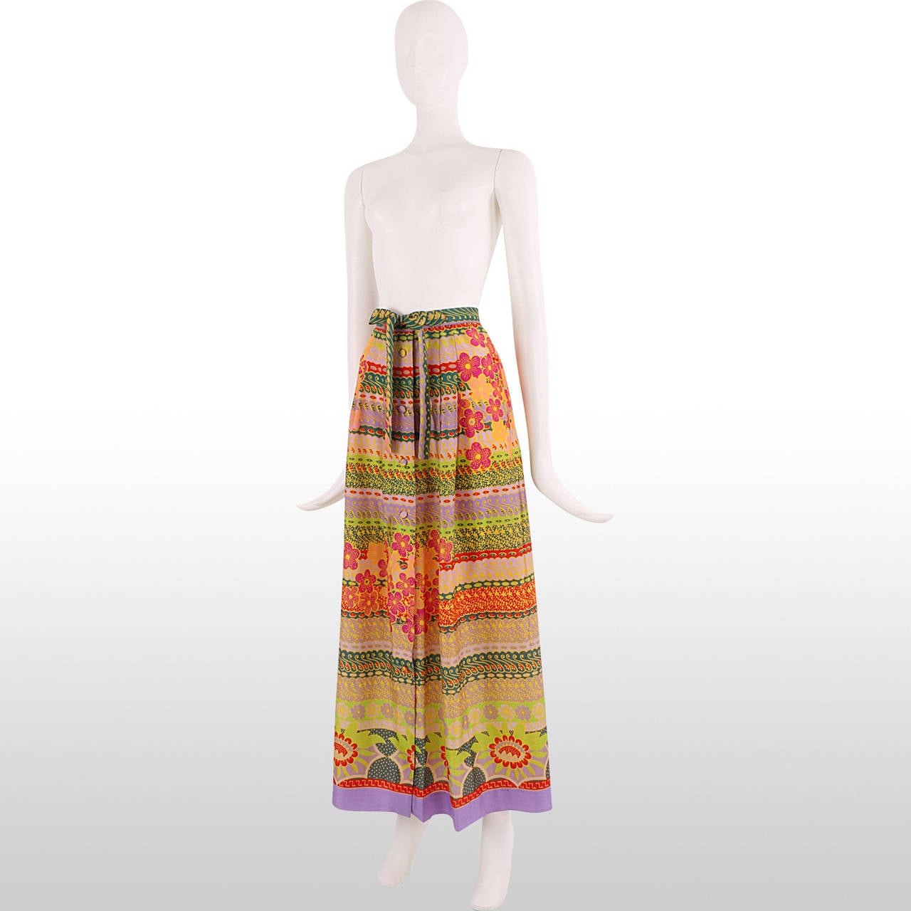 Vibrant 1970's maxi skirt from original designer J. Tiktiner for Harrods. The skirt features a fun tropical and floral print with psychedelic style swirls, making the piece really pop. The skirt also features a button down centre and tie waist,