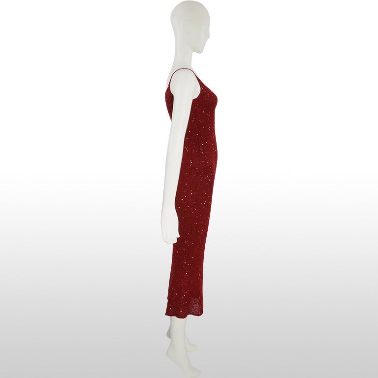 Our Future Collectible range presents this Donna Karan dress which is made from a deep red knitted cashmere and silk blend and fully embellished with tiny glass beads and sequins. The knitted fabric causes this body-con dress to hug the figure