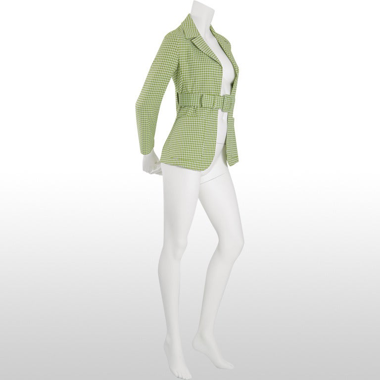 This lovely Marni Jacket is made from a cotton/nylon blend which is woven into a small square check design in moss green and ivory. The jacket fastens with a coordinating wide buckled belt which fits at the waist at the front to create a figure