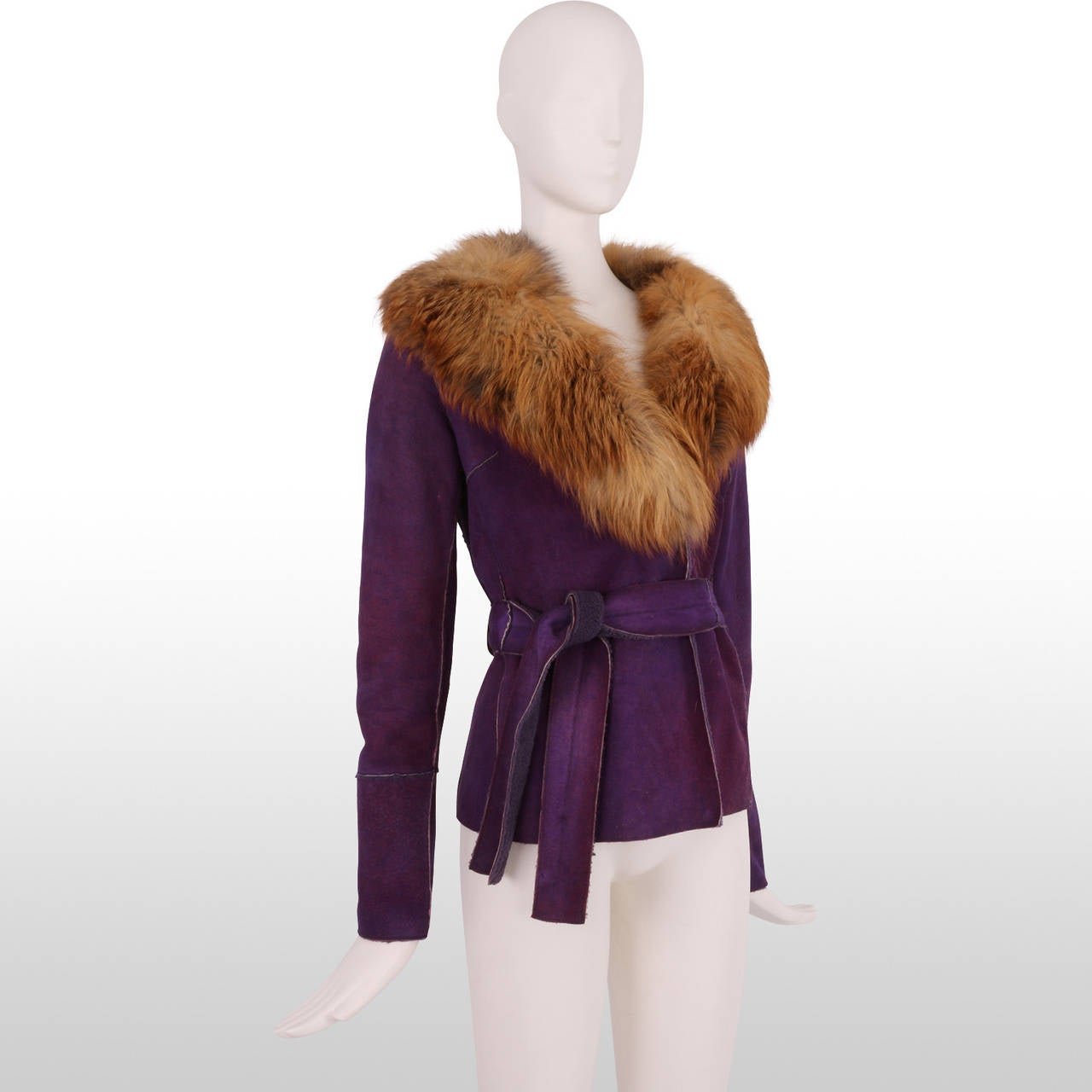 The perfect transitional jacket to take you from autumn into winter, this rich regal purple shearling jacket has a short clipped wool lining and the collar is trimmed in fur. The jacket closes with two snaps and a detachable belt to close. It is in