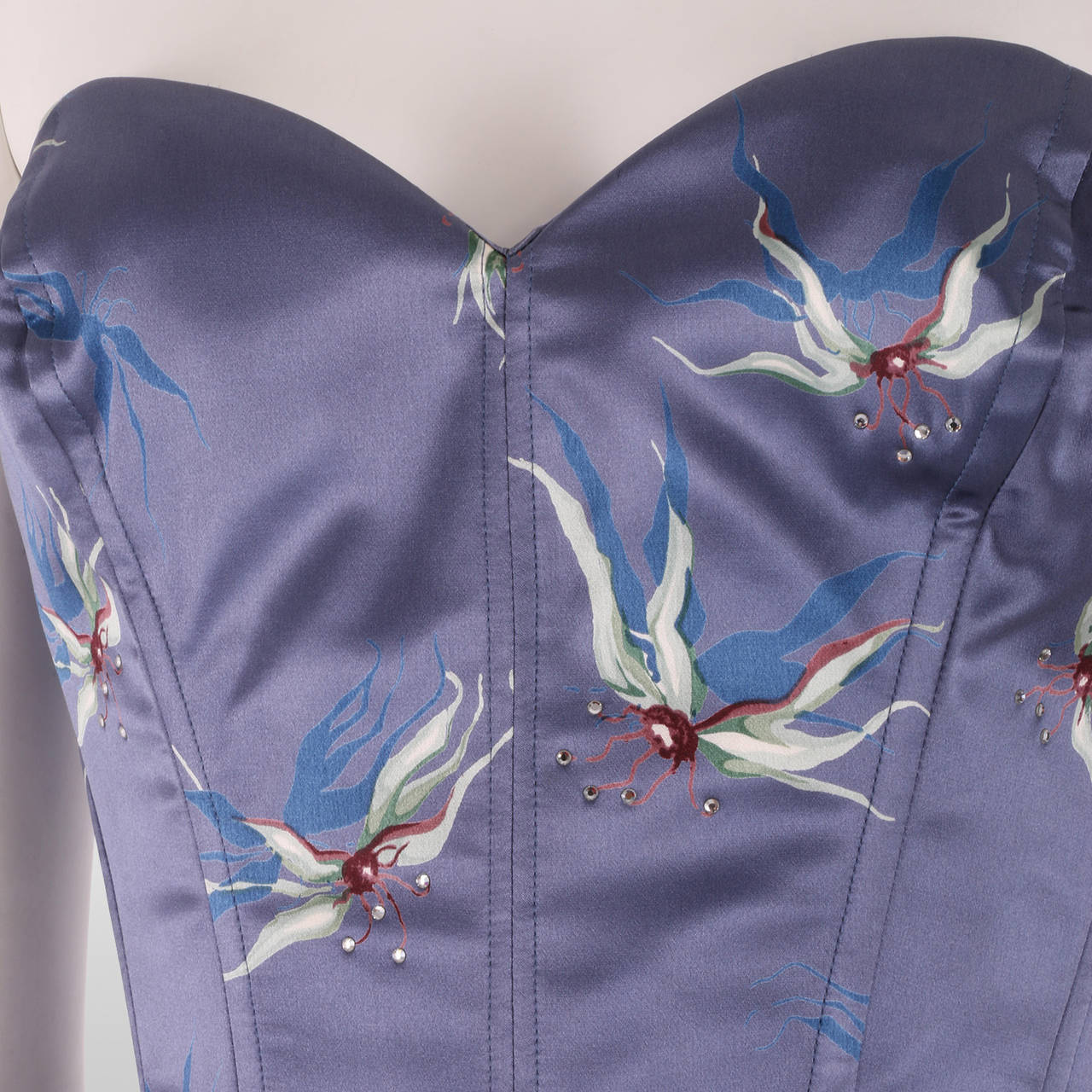 This beautiful satin blue with flower embroidery corset, is part of Chloe's Spring/Summer 1999 ready to wear collection. It was also showcased as part of their advertising campaign in 1999. The same print was worn by Gisele Bundchen on the runway.