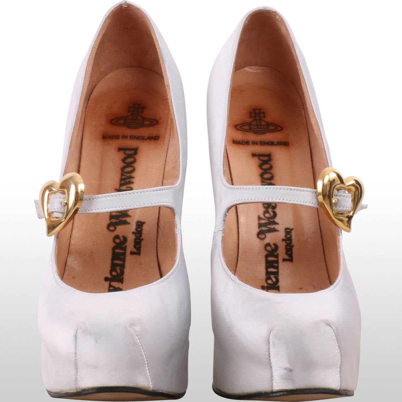 These beautiful one of a kind white satin high heals where custom made for Tiger Savage - by Vivienne Westwood - for her wedding day. The golden heart shaped buckle adds that very special detail to these otherwise beautifully simple shoes.