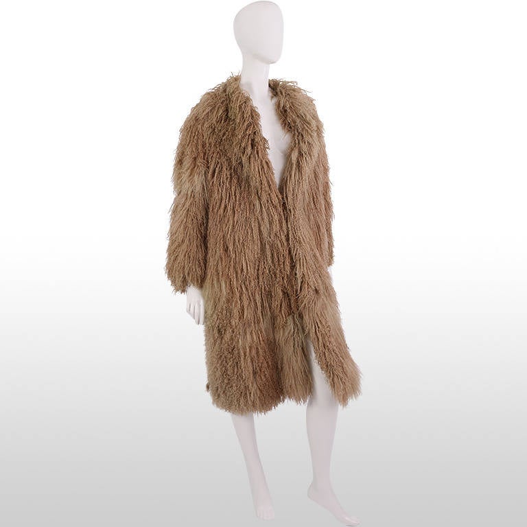 This gorgeous 1970's  coat is made of Mongolian curly lamb wool and will definitely keep you warm this winter! It is fully lined in synthetic fabric with an inside pocket on the right hand side. The luxurious lambswool has a mixture of caramel and