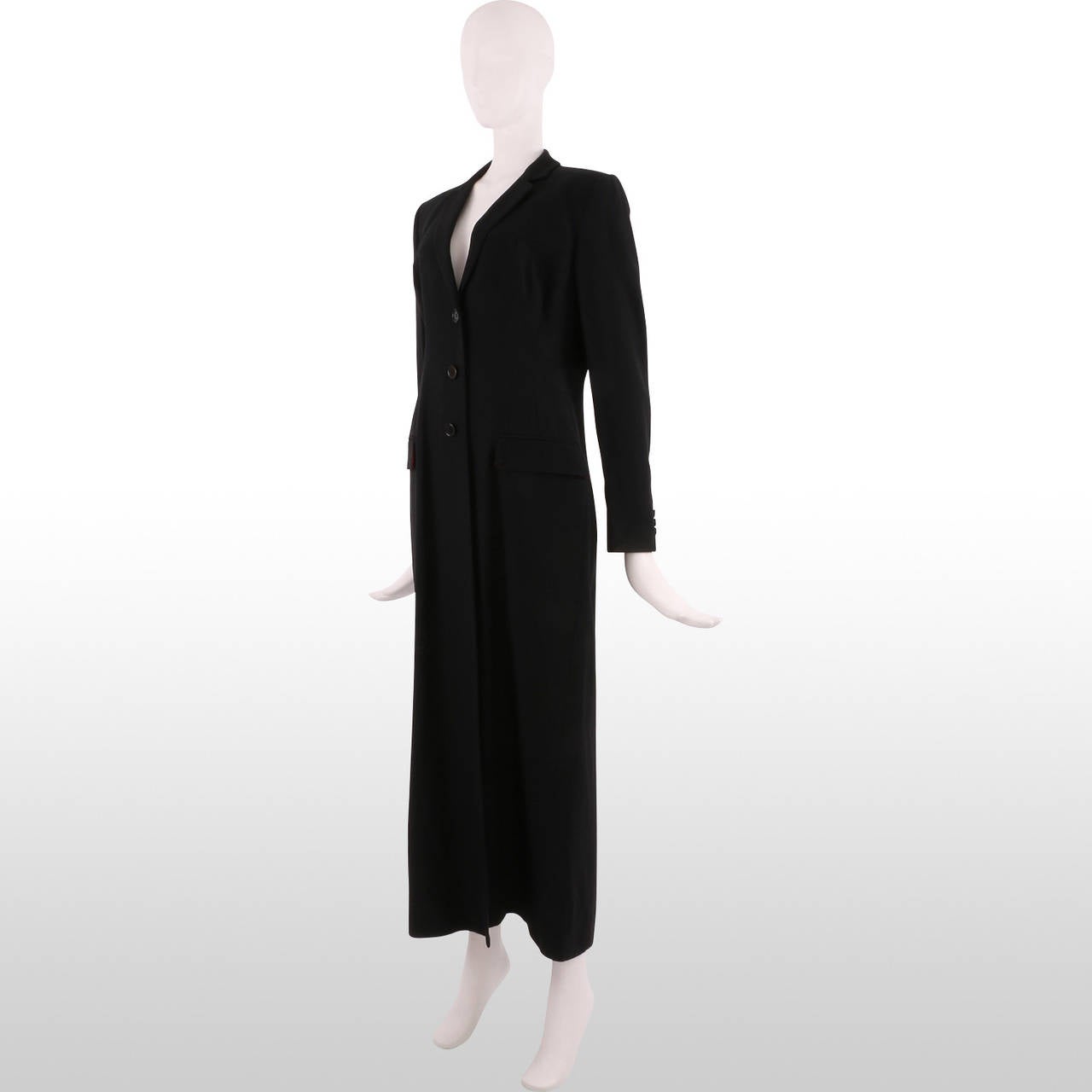 This beautiful piece is a Dolce & Gabbana creation. The bright black and the length of the garment gives an elegant touch to any look, while the slightly fitted cut makes it just feminine enough. This will be perfect for a classy night out. The coat