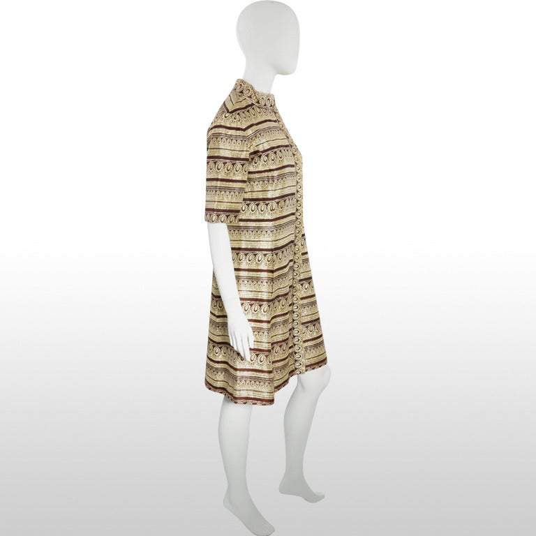 This beautiful Ceil Chapman dress is a rare collectors’ piece from the 1960’s and perfect for the festive season! This is a unique dress in that it looks like a coat but it is actually a dress. It is made from a lush gold metallic and matte brown
