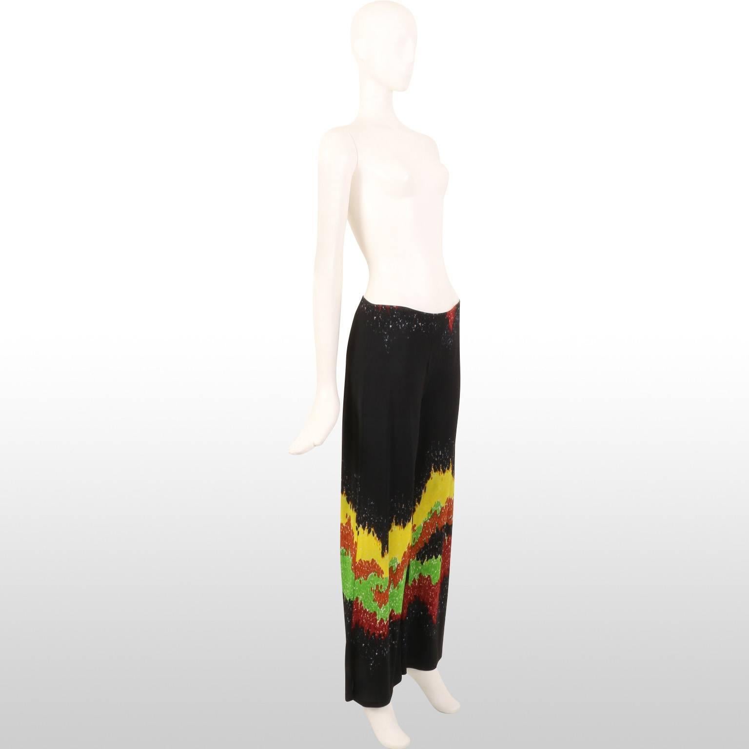 These are fun, wide leg loose fitted black trousers with a seismograph multicoloured pattern detailing. The trousers are designed by Jean Paul Gautier. The piece is made out of acetate and nylon. It remains in excellent condition. 