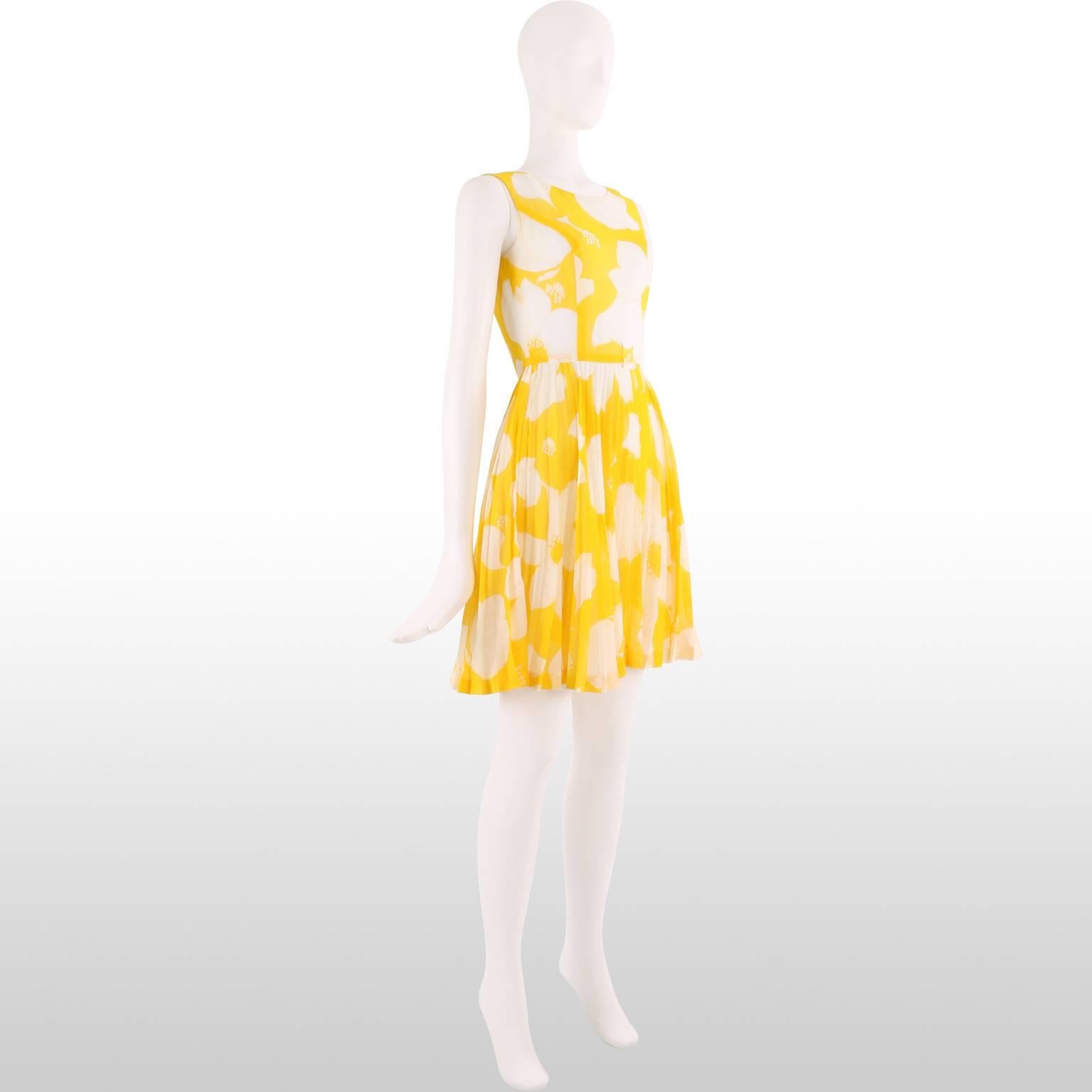 Beautiful and bright sunshine yellow 1960's dress is made from a lightweight cotton blend printed with a fun ivory floral design. This sleeveless dress has a fitted bodice and a full pleated skirt. Fun and exciting, this garment exudes summer and