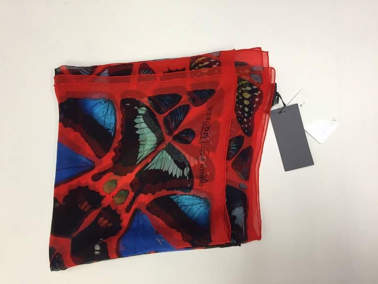 Sharing their passion for unusual beauty Alexander McQueen and Damien Hirst started a collaboration which celebrated their love for the quirkiness of the elements of Nature. This magnificent butterfly print silk scarf is mainly red with hints of