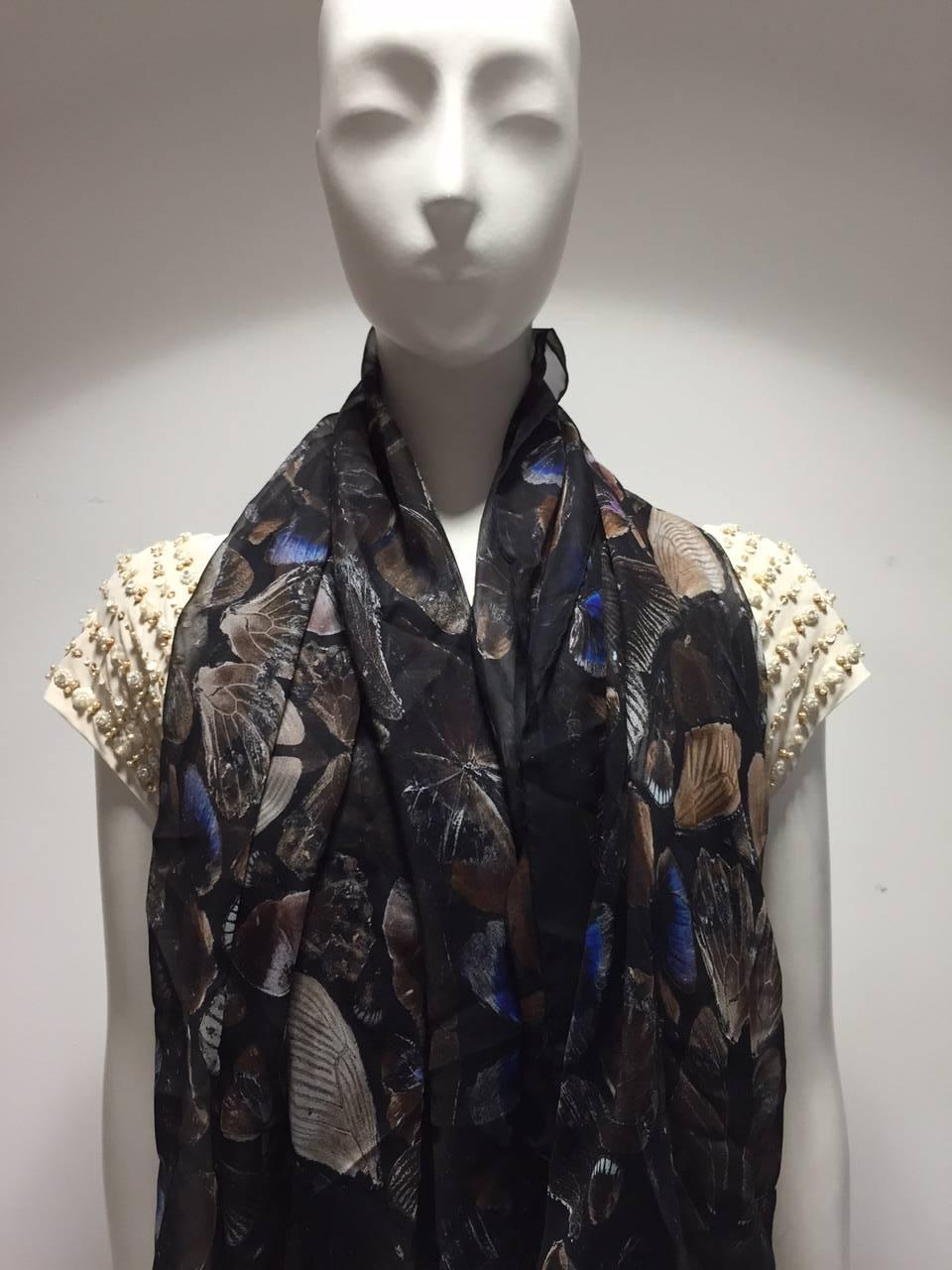 This black silk scarf with an exquisite butterfly pattern is part of the collaboration series between Alexander McQueen and artist Damien Hirst. A rare find, new with tags. 