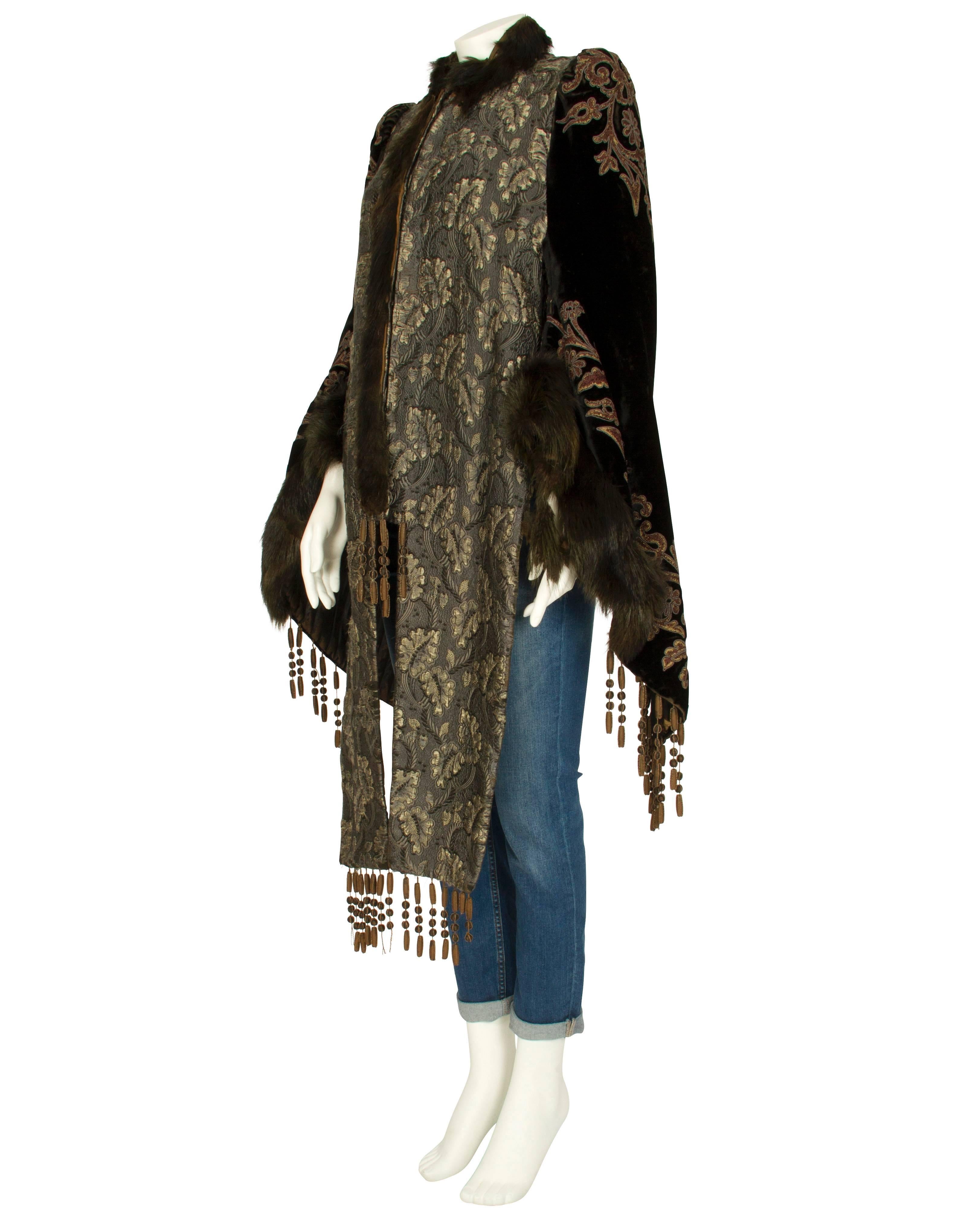 This exquisite embroidered jacket blends oriental look with aristocratic flair. Unique features include an intricate brocade pattern with a chevron quilted back and gathered velvet bell shaped sleeves. The fur neck and sleeve trim add to luxurious