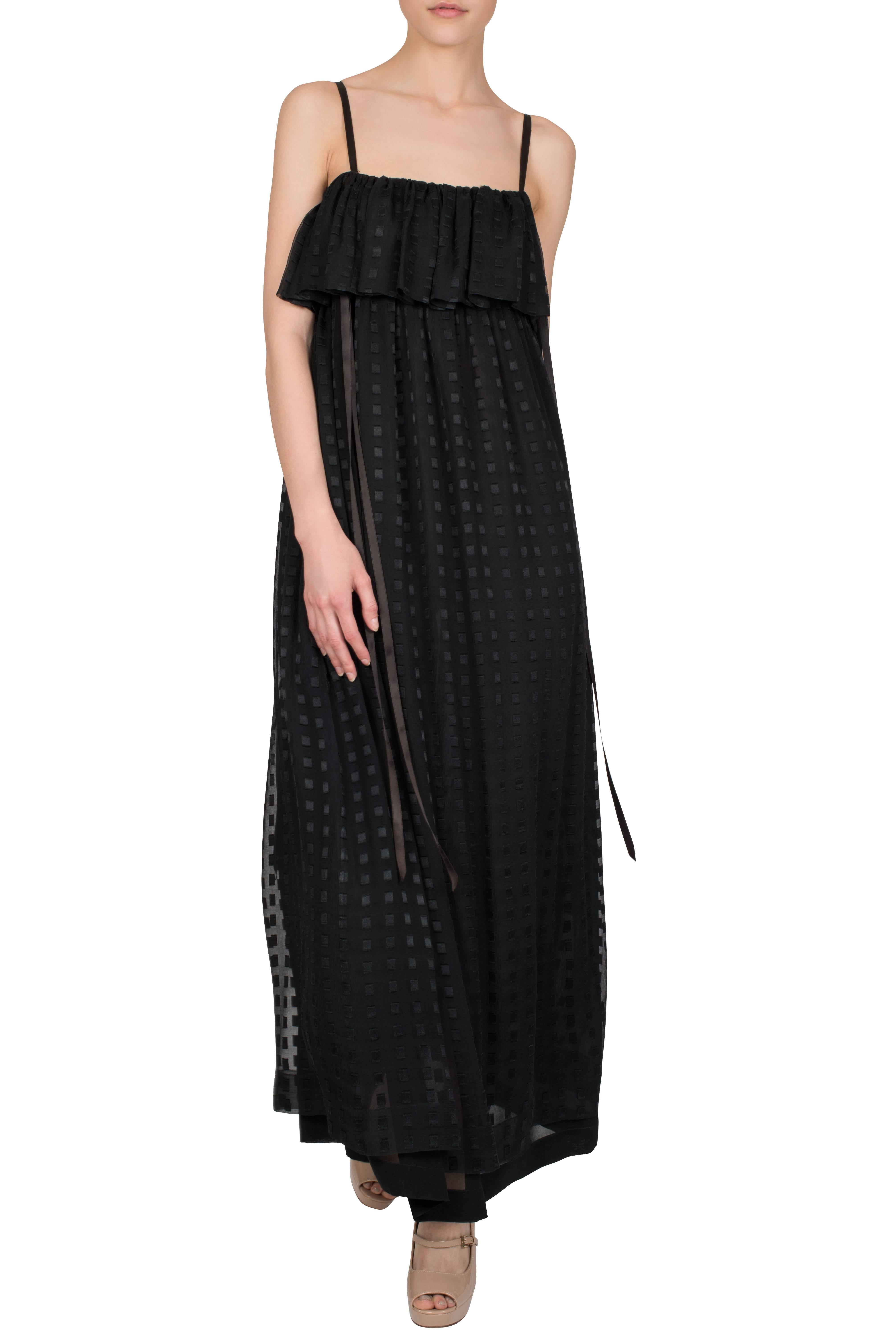 An elegant 1980s Christian Dior Boutique sleeveless black silk chiffon evening dress with a layered neckline and embossed square pattern. The full-length dress features thin black silk straps and black silk ribbons that tie under the arms. The dress