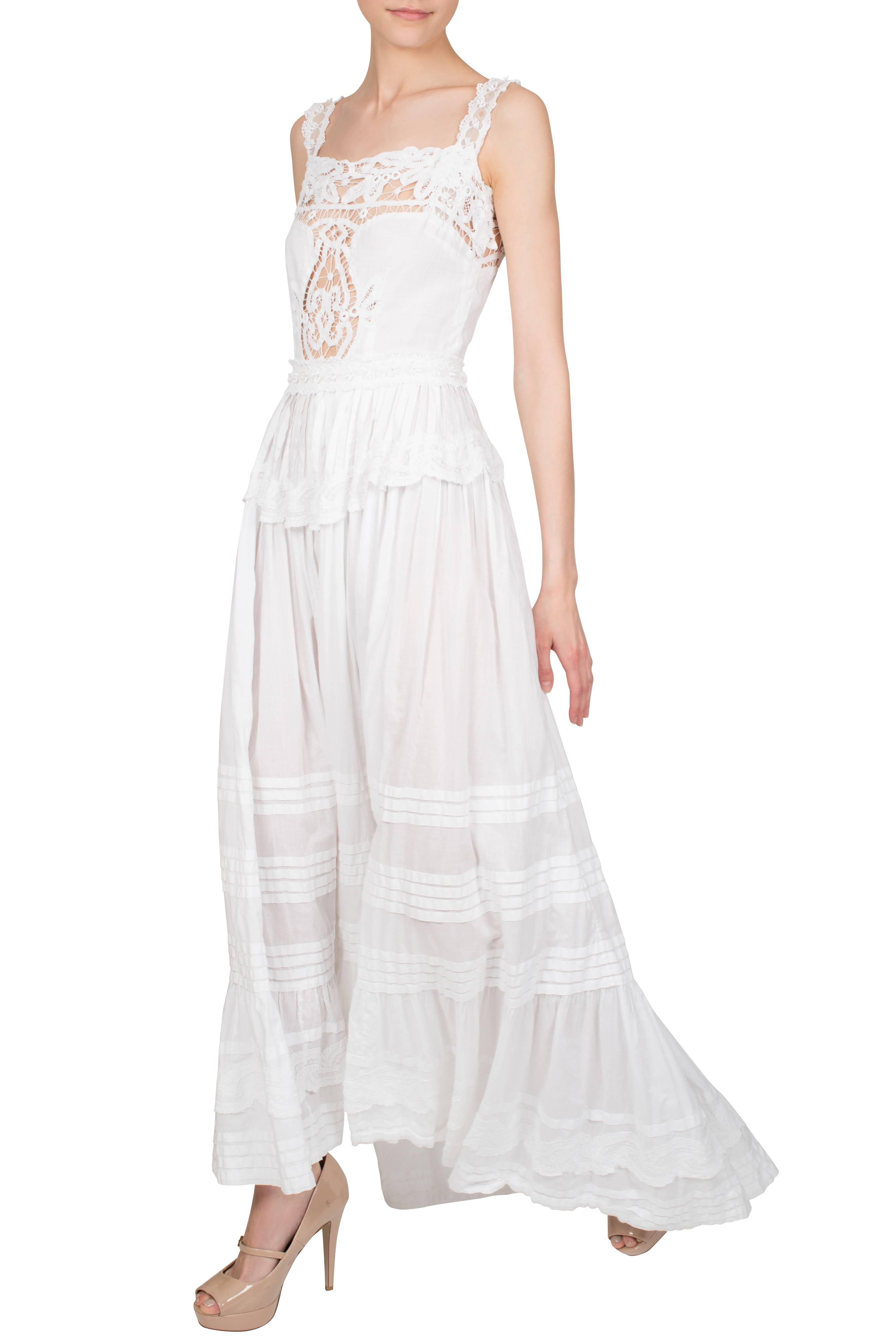 A one-of-a-kind 1970's white cotton maxi dress with lace detailing designed by Hollywood costume designer Theodora van Runkle for Miranda Quarry during her marriage to Peter Sellers. The Victorian style, sleeveless dress features white lace and