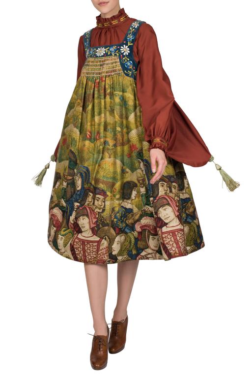 An incredibly rare and highly collectible Bill Gibb for Baccarat linen and velvet pinafore dress featuring appliqued Renaissance portraits on the skirt from Fortnum and Mason in London. The dress was featured in British Vogue’s October 1970 issue.