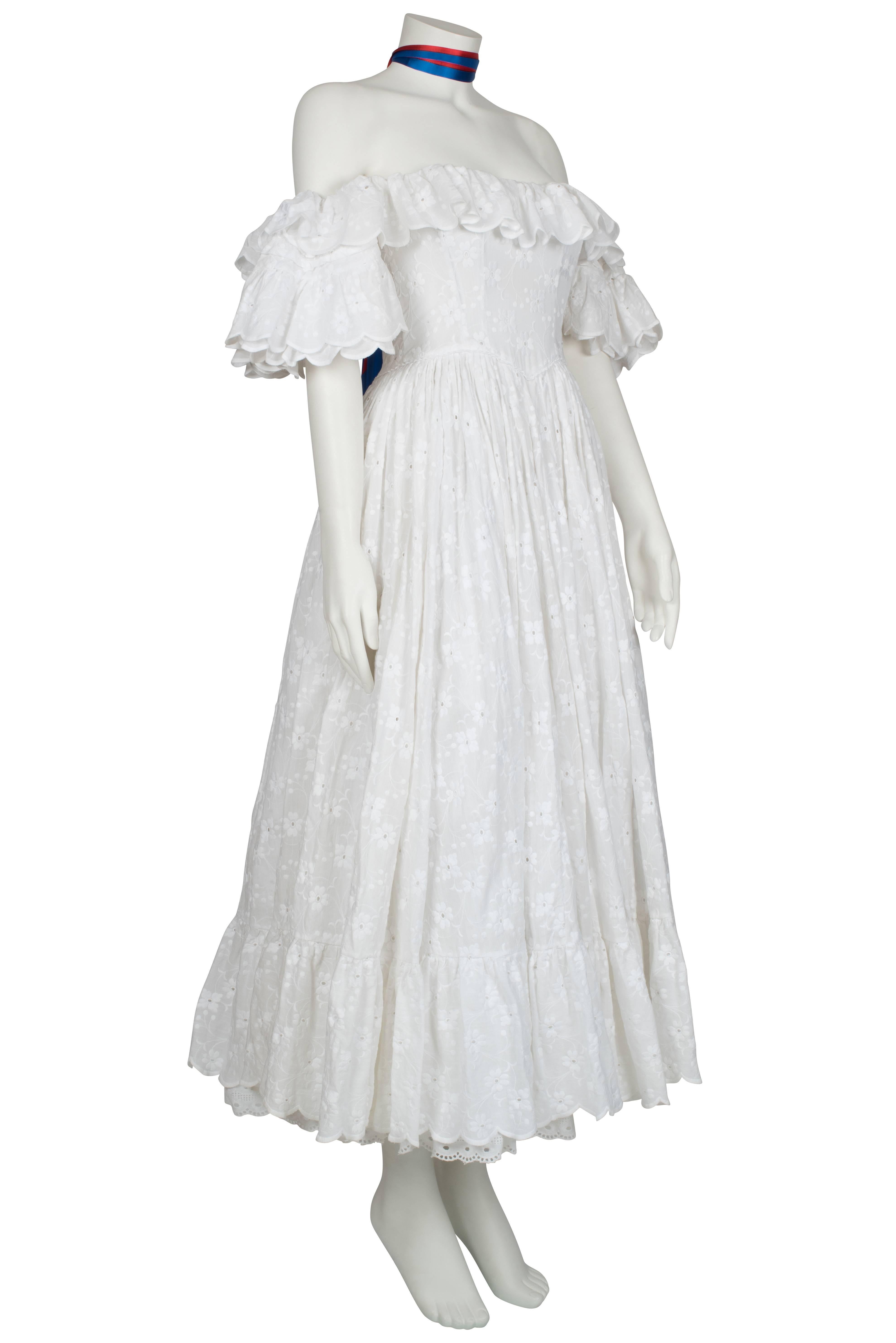 A one-of-a-kind Ossie Clark couture white broderie anglaise cotton full-length dress. This dress was custom made for Miranda Quarry to wear to the American Independence Bicentennial Ball in July 1976. This particularly heavy dress has a fitted