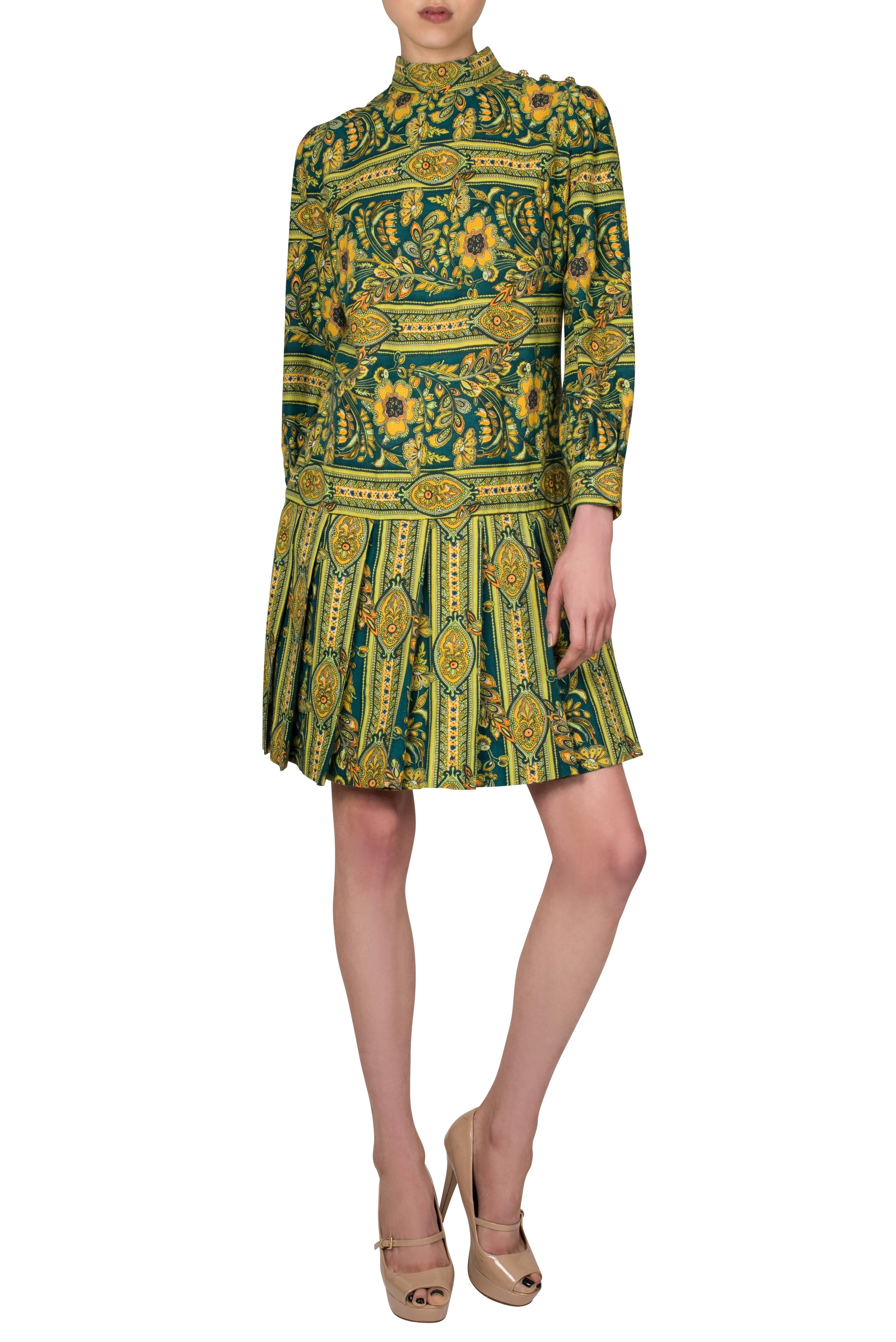 Striking late 1960's Leslie Fay soft woven mini dress in vibrant green and yellow paisley print, featuring a stand up collar with diamante buttons on the left shoulder and barrel sleeves with cuffs pulled together by a large covered button.