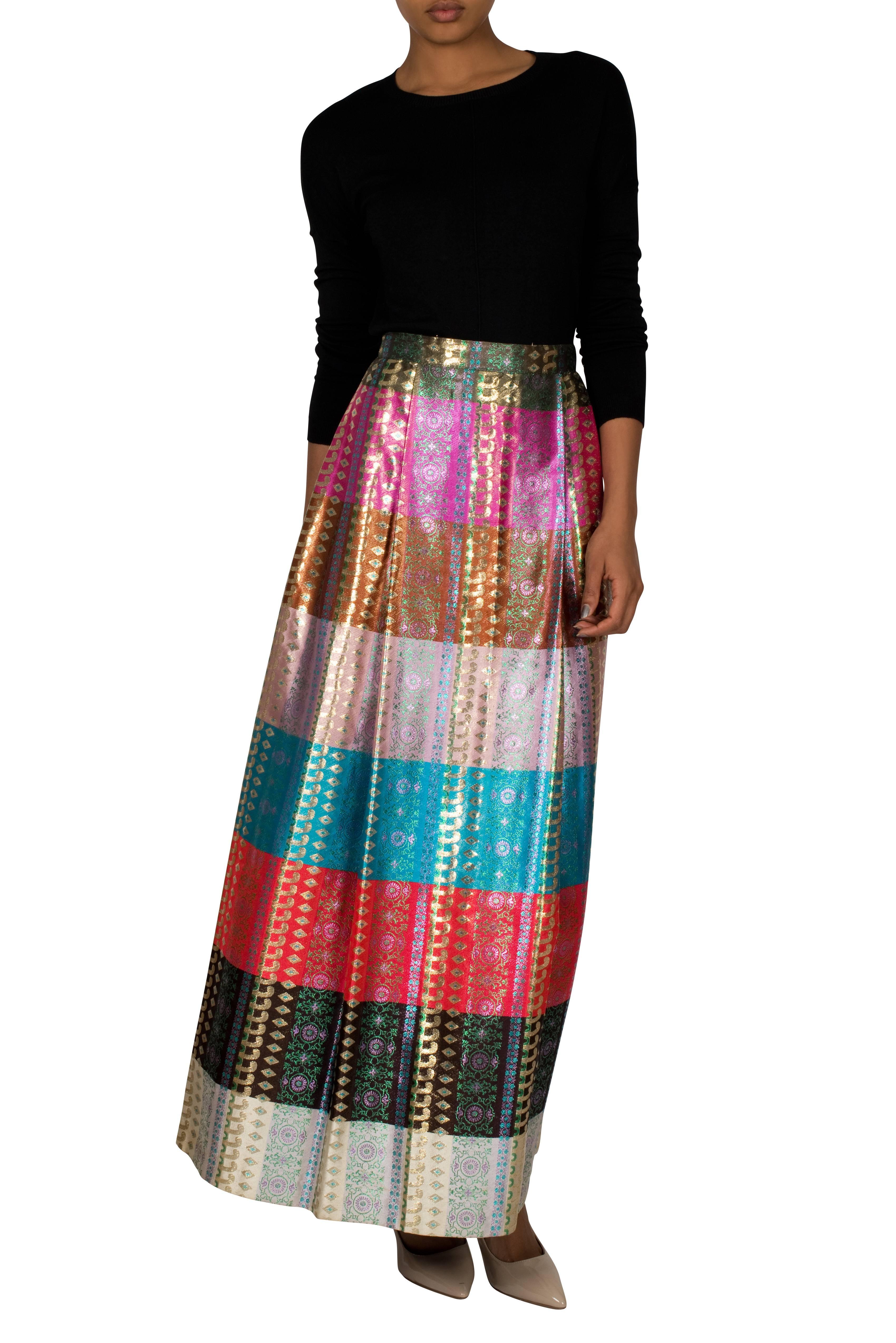Elaborate 1970's maxi skirt with multicolour bands. The striking colours of the horizontal stripes are enhanced by the luxurious sheen, which translates glamour onto this beautiful piece. The metallic fibres in the fabric make it slightly rough to