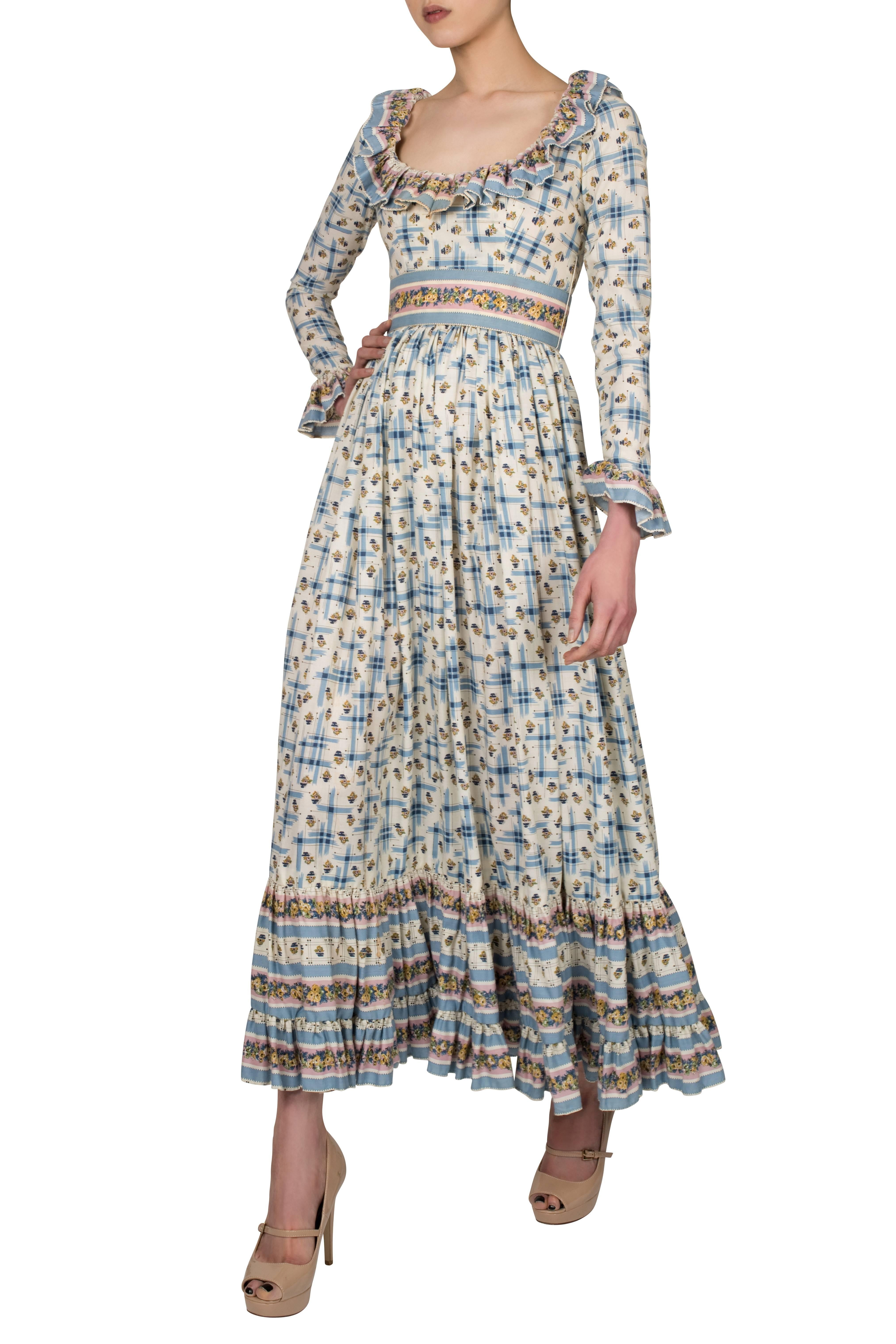 Romantic 1970's dress by Victor Costa in prairie style, in a soft cotton blend, possibly cotton and viscose (no fabric label) with a dainty floral pattern in ivory, pink and blue. The dress has a very flattering round décolletage decorated with a