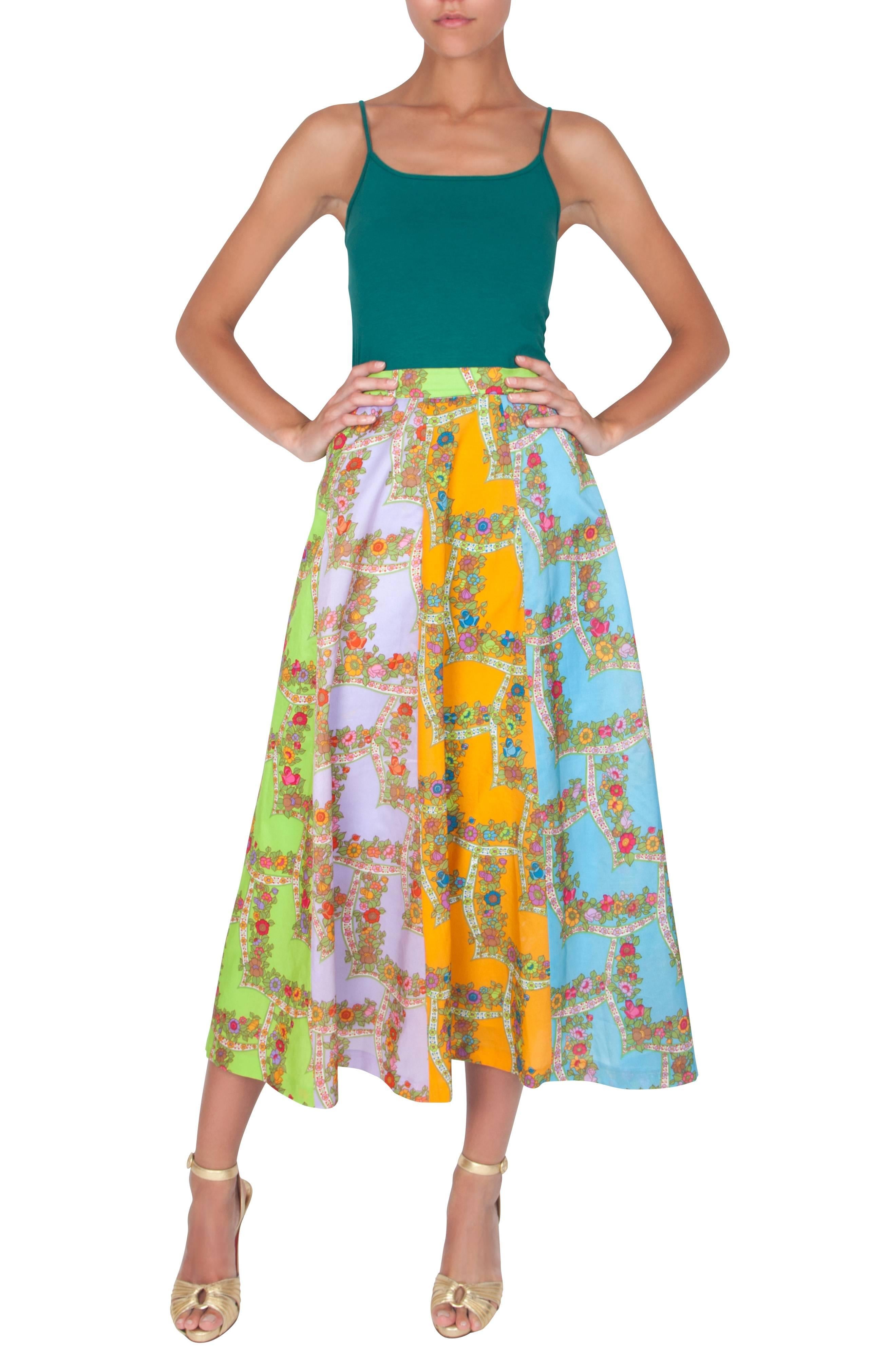 1970s bright and colourful flowy circle skirt with floral grid pattern. Made from a lightweight silky polyester, this midi length skirt has a back hook and snap closure, and a breathable synthetic lining.  A Belinda Bellville design, however, the
