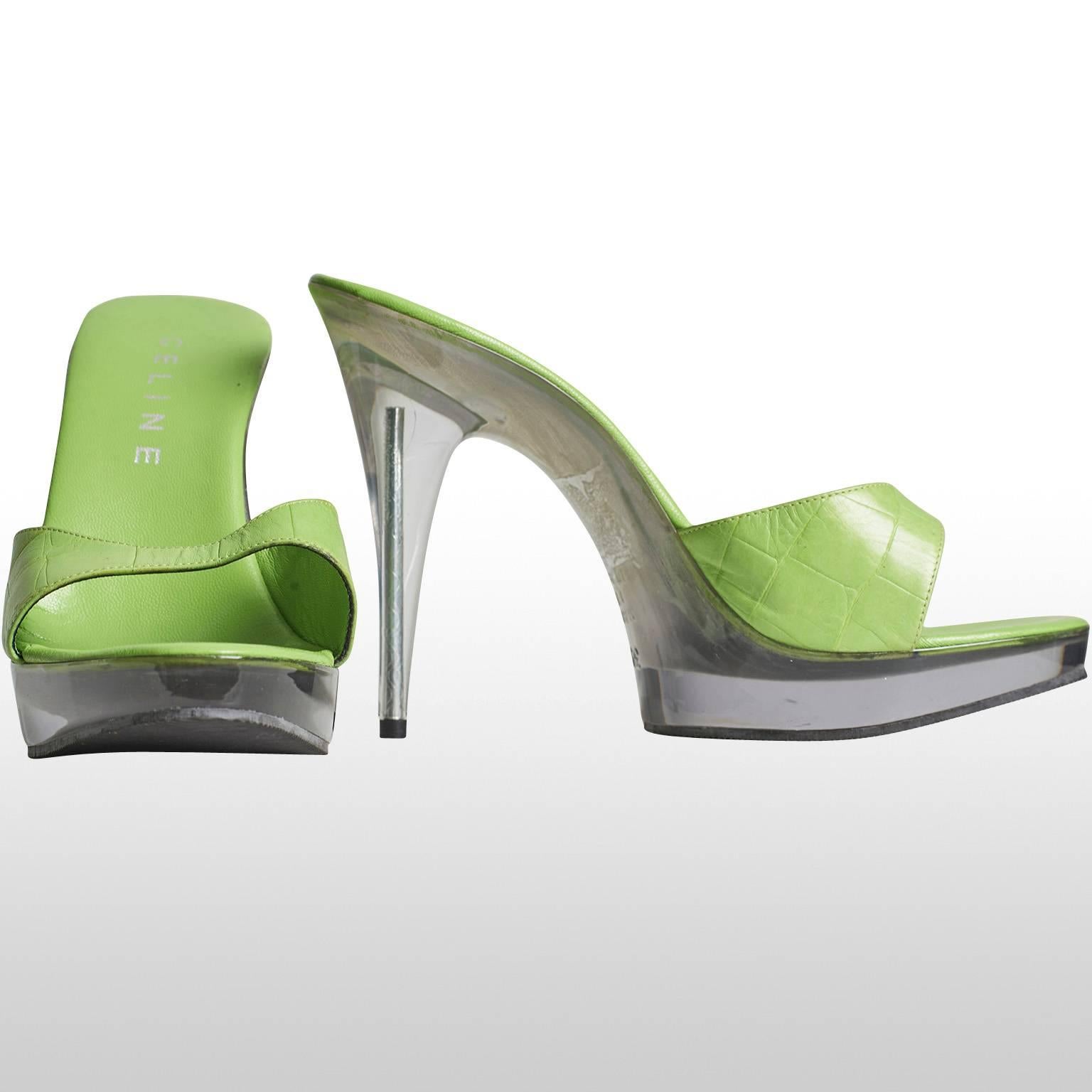 This is a playful lime green platform sandal by the designer Celine. The platform is one inch high and the total hight of the heel is five inches tall. Both the platform and the heel is made out of a clear plastic. The insole and the vamp of the