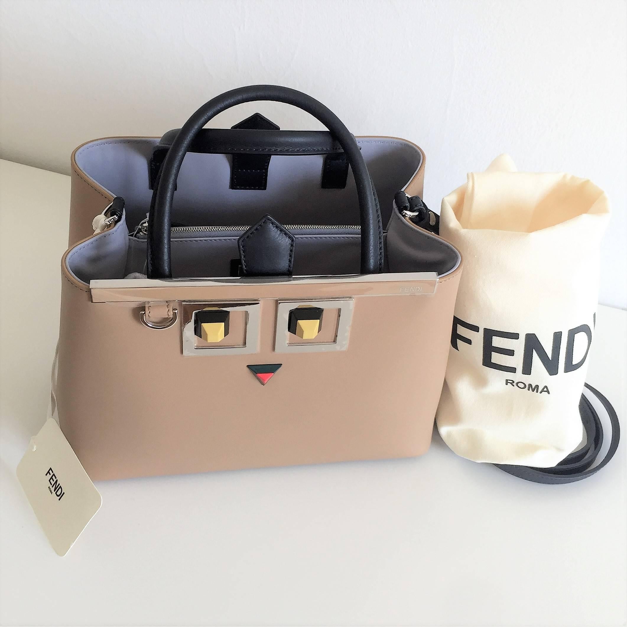 This is an unworm brand new 2017 Fendi 'Occhi' tote made in camel-coloured calfskin leather decorated with metal appliqués and two-tone studs that create the iconic Square Eyes motif. Enamel bar with Fendi logo. Palladium edging and metalware.