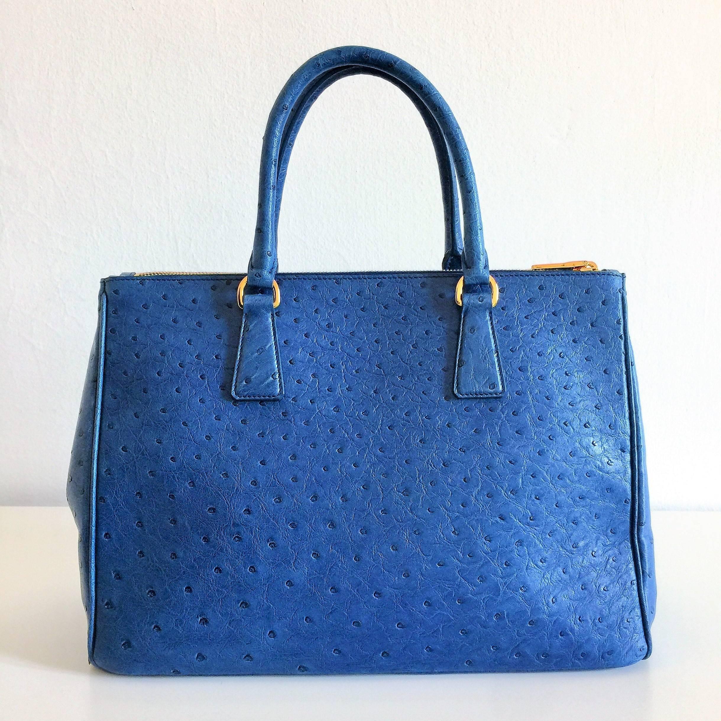 This is a pristine Prada bag made in a marvellous cobalt-blue ostrich leather the bag has been worn once in its life so it's in pristine condition. This double zip tote comes with its complete set of original accessories: shoulder strap, dustbag,